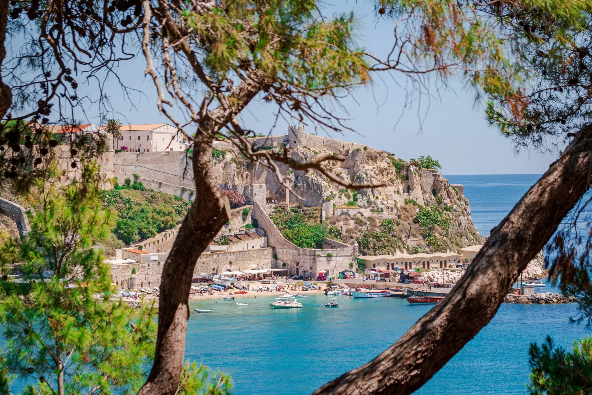 Aerial view of San Domino's limestone cliffs with small boats anchored in sheltered bay