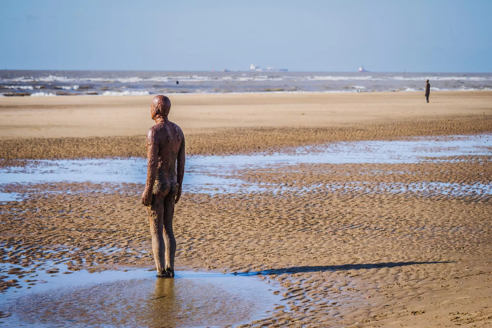 Antony Gormley statues on the sand at Crosby Beach in Merseyside, near Liverpool, England.