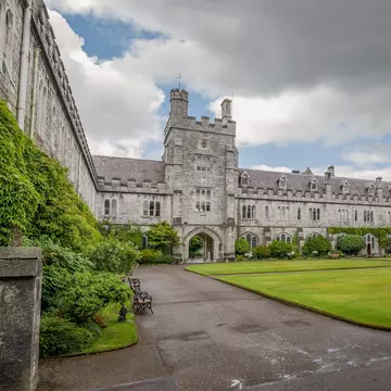 Long Hall and Clock Tower of University College Cork, Cork, Ireland.   Green lawn.