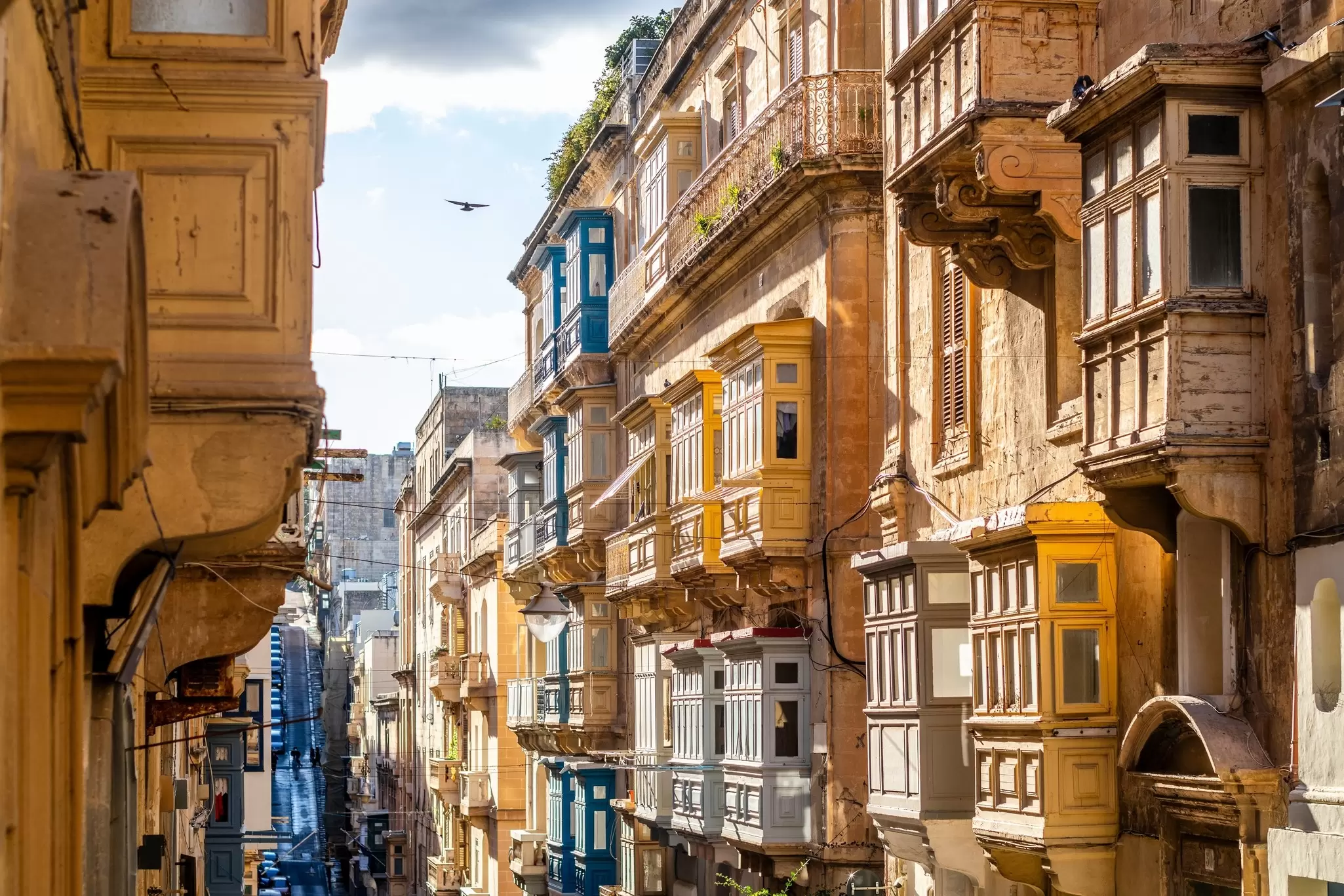 Wooden balconies on buildings in warm colors.