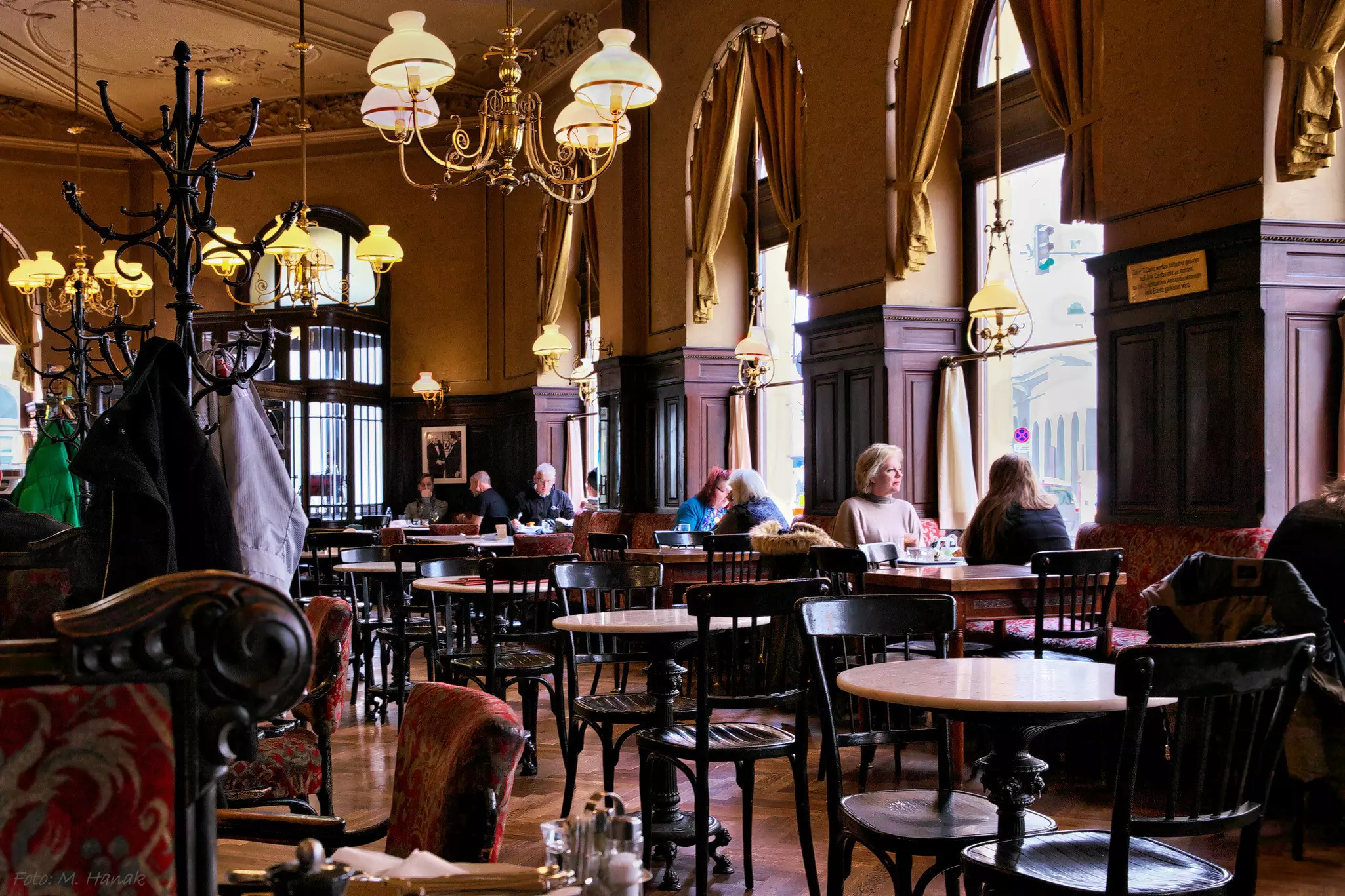 People sit at tables inside Coffee Sperl in Vienna.