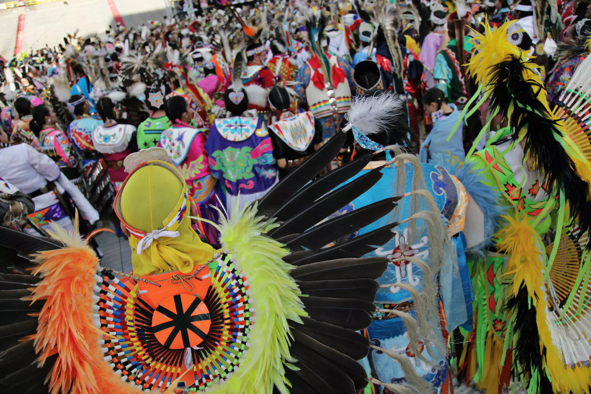 People in colorful Native costumes take part in a festival