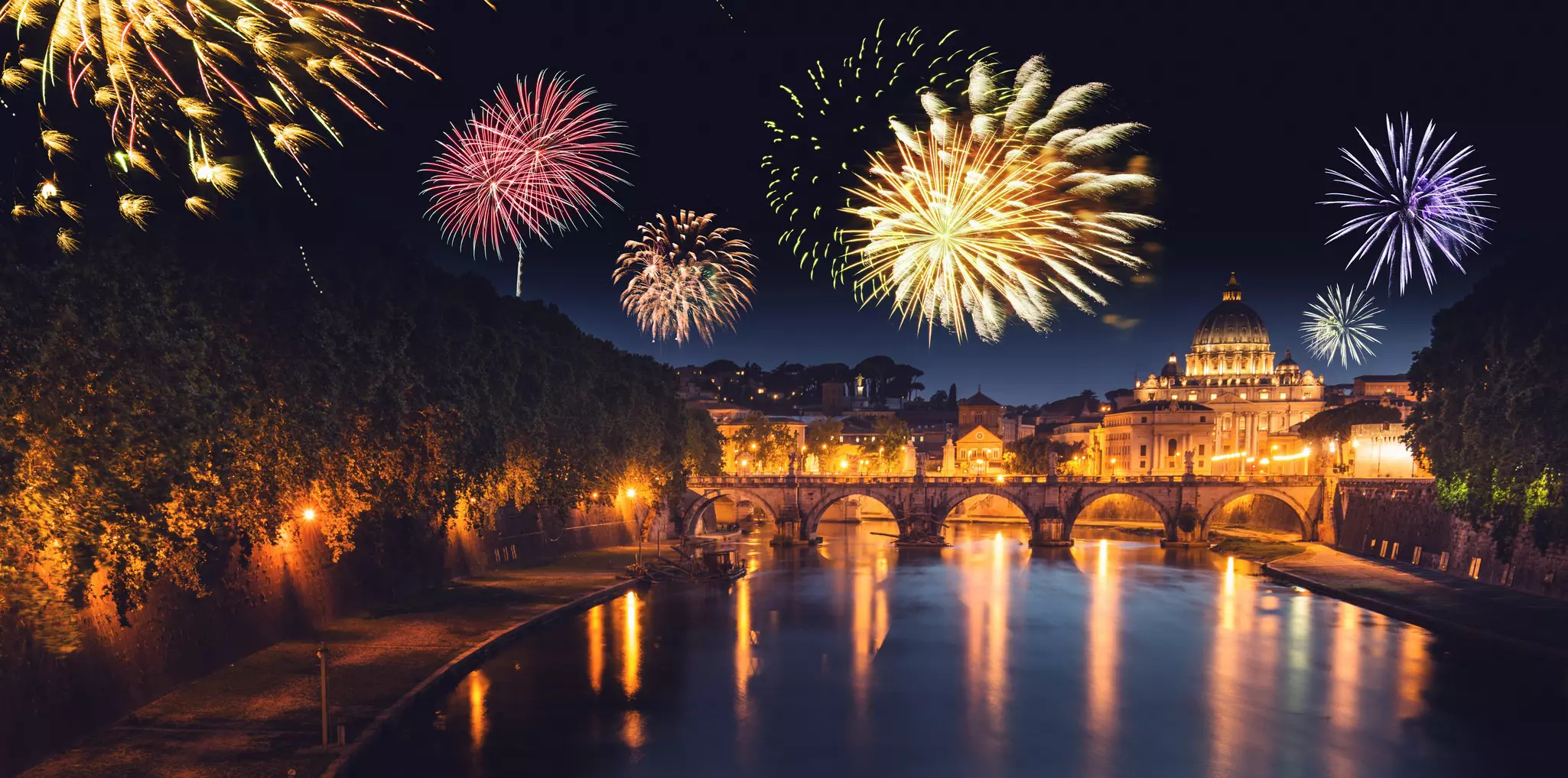 Rome skyline with colorful fireworks over the water at night
