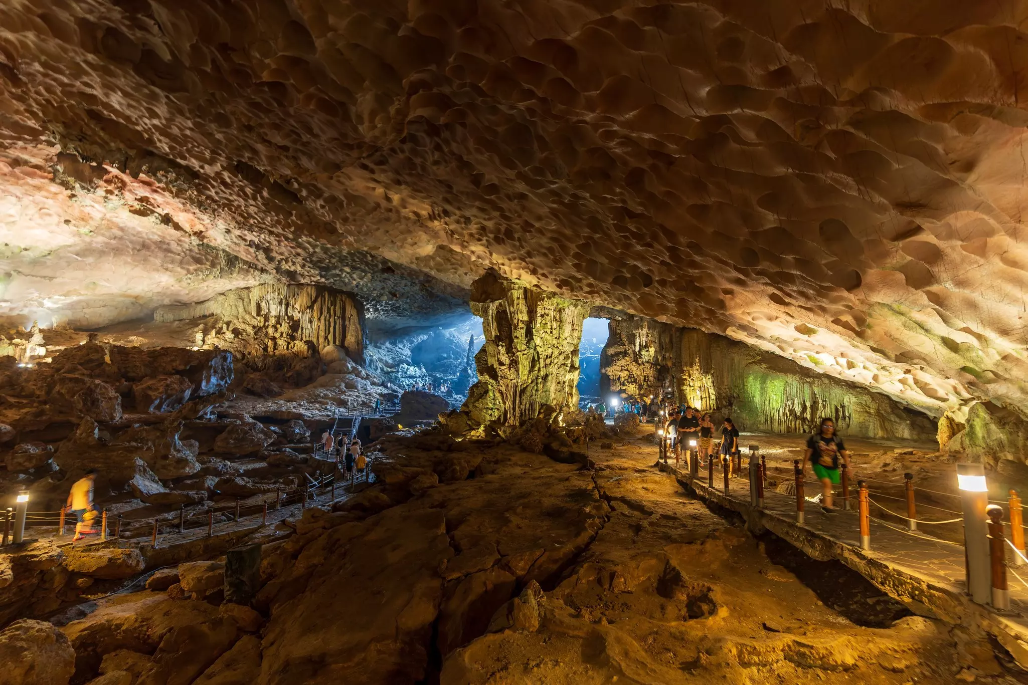 Visitors walk on platforms through a cave in Vietnam.