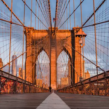 Visitors crossing the Brooklyn bridge during the early morning.