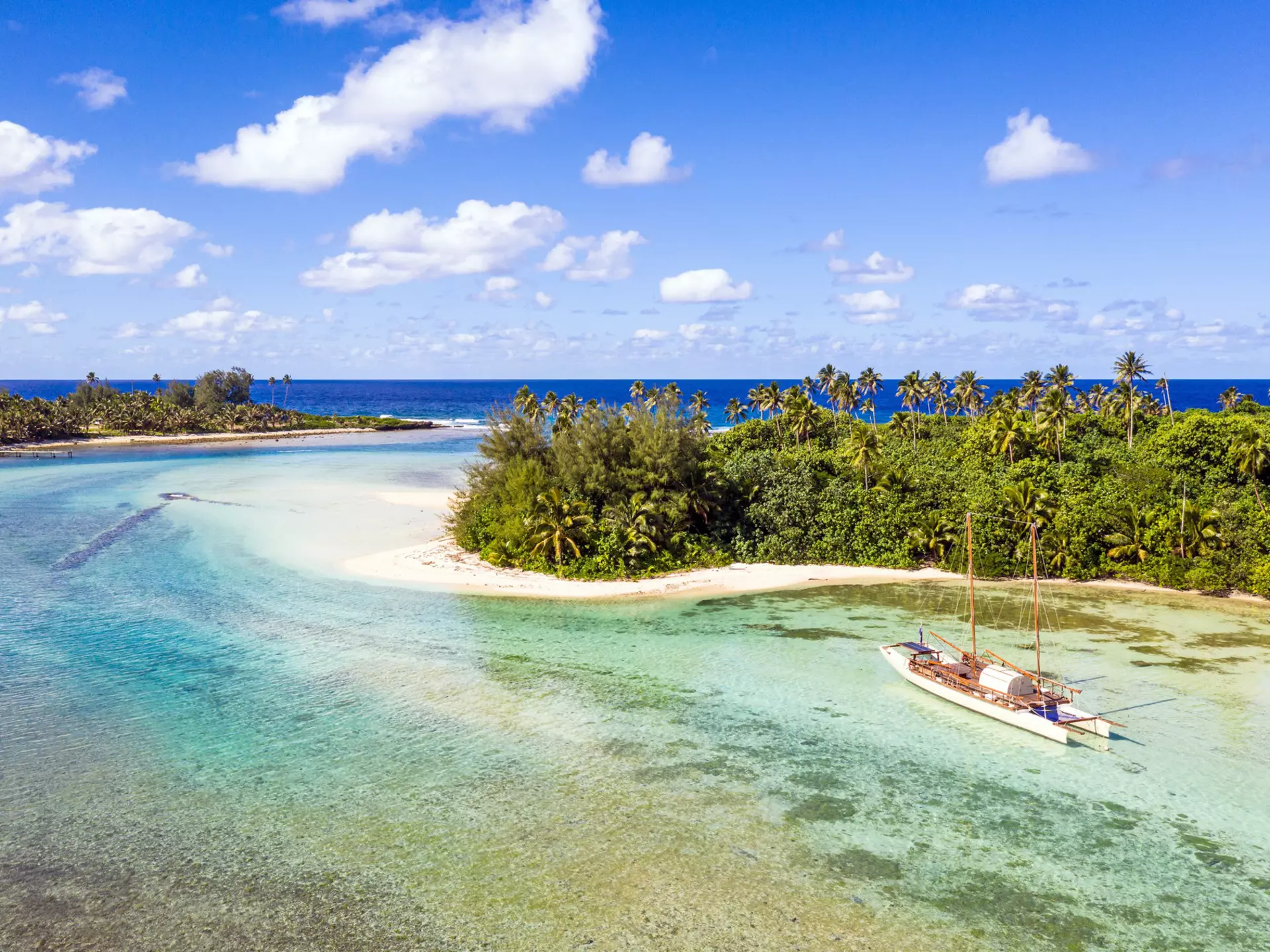 Sailboat in a lagoon next to trees