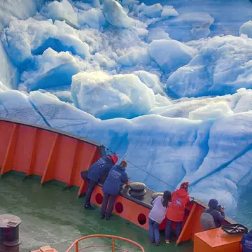 Franz Joseph Land - 10 July 2016: Tourist cruise in high Arctic. Ship sails close to small iceberg. But we should remember that 90% of ice mountain is under water. Titanic Iceberg was a little more, License Type: media, Download Time: 2025-05-28T09:54:09.000Z, User: lonelyplanetmedia, Editorial: true, purchase_order: 65050 - Digital Destinations and Articles, job: Global Publishing WIP, client: Global Publishing WIP, other: Peterson Haggarty // SS Comp Ingestion