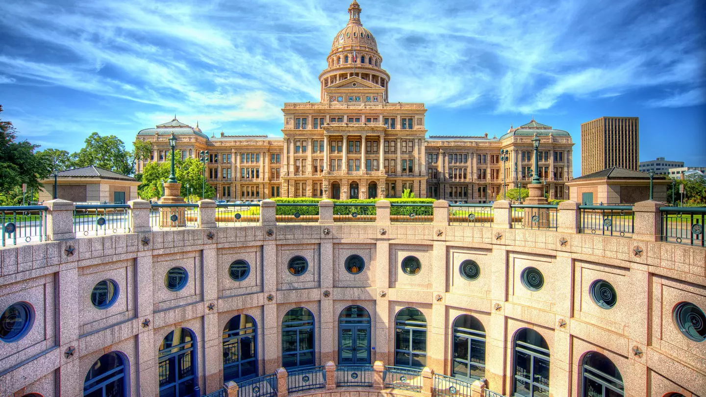 The stunning rotunda of the Texas State Capitol with the main building in the background
