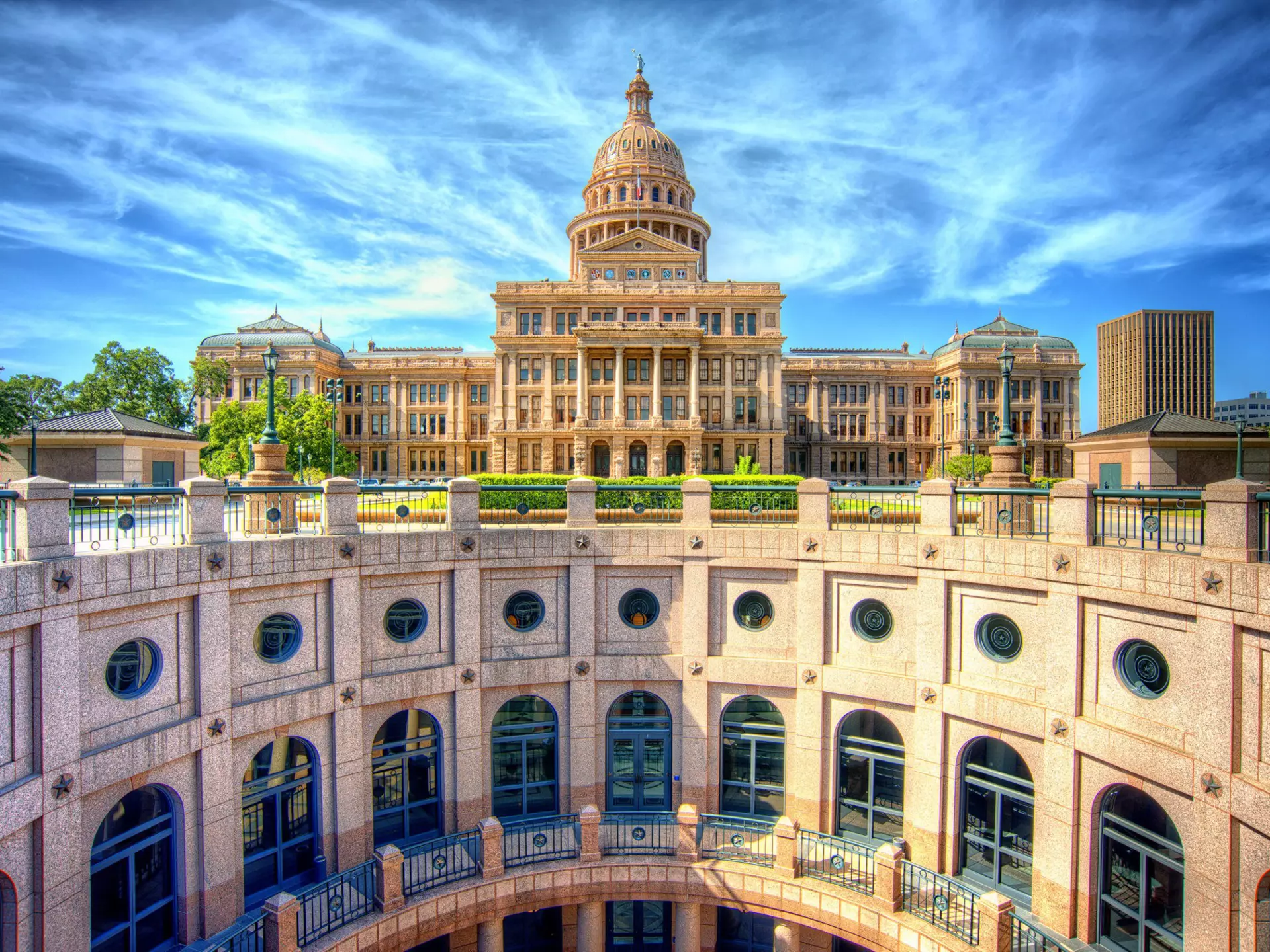 The stunning rotunda of the Texas State Capitol with the main building in the background