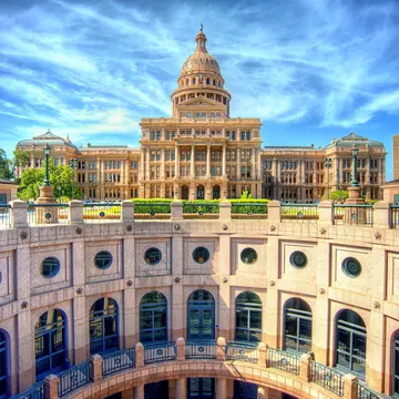 The stunning rotunda of the Texas State Capitol with the main building in the background