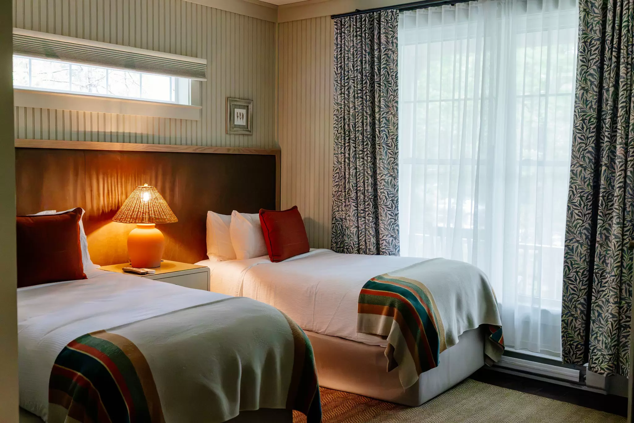 Two twin-size beds in a cozy hotel room