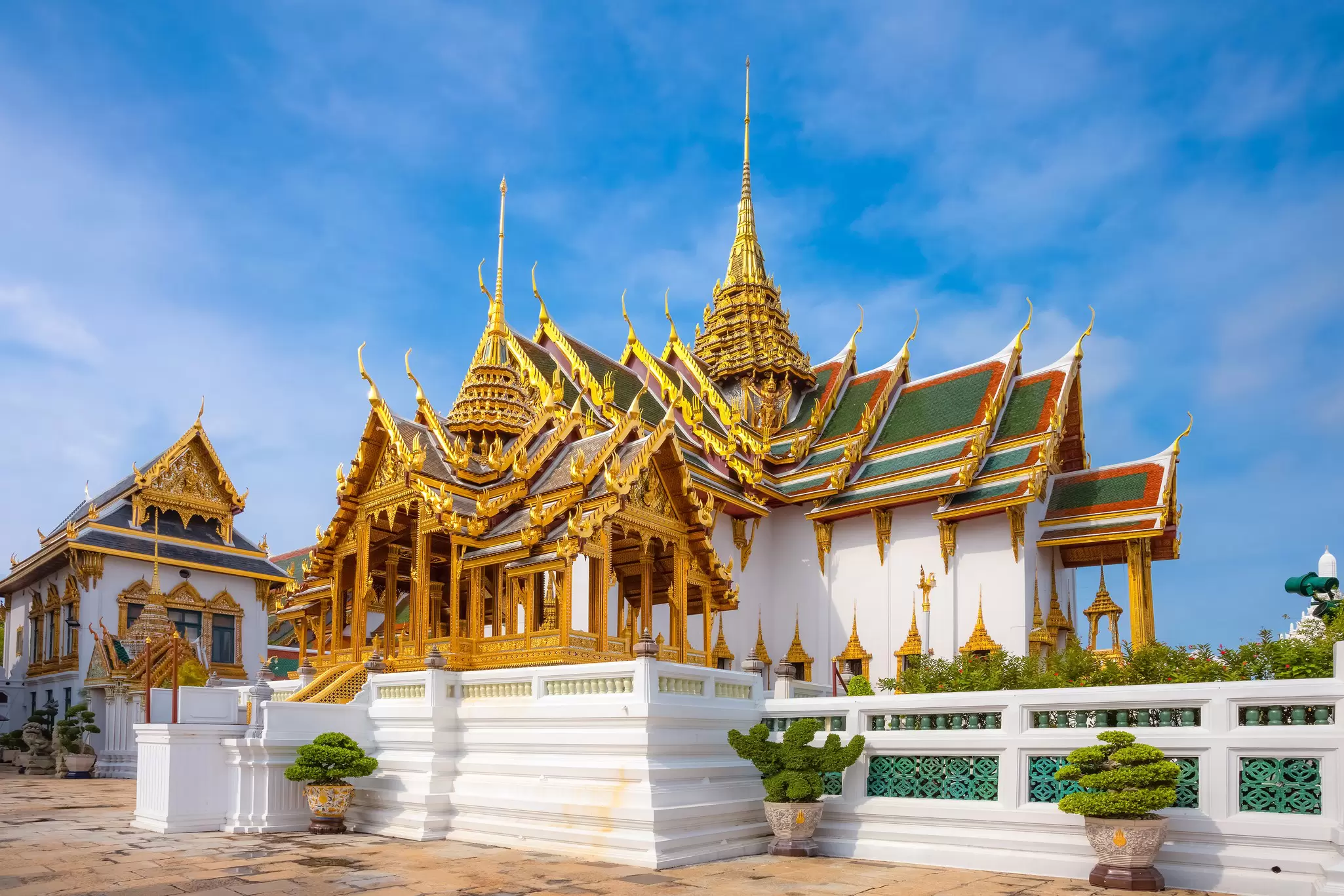 Exterior view of Dusit Hall on a sunny day at the Grand Palace in Bangkok, Thailand.