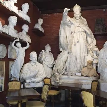 25779-99
Europe, Italy, Lazio, Rome, absence, arrangement, art, bust, cafe, ceramics, chair, collection, colour, culture, eating out, female likeness, food & drink, furniture, horizontal, human representation, indoors, large group of objects, male likeness, no people, order, sculpture, seat, shelf, statue, table, white
Museo-Atelier Canova-Tadolini sculptural studio and cafe, Tridente area.