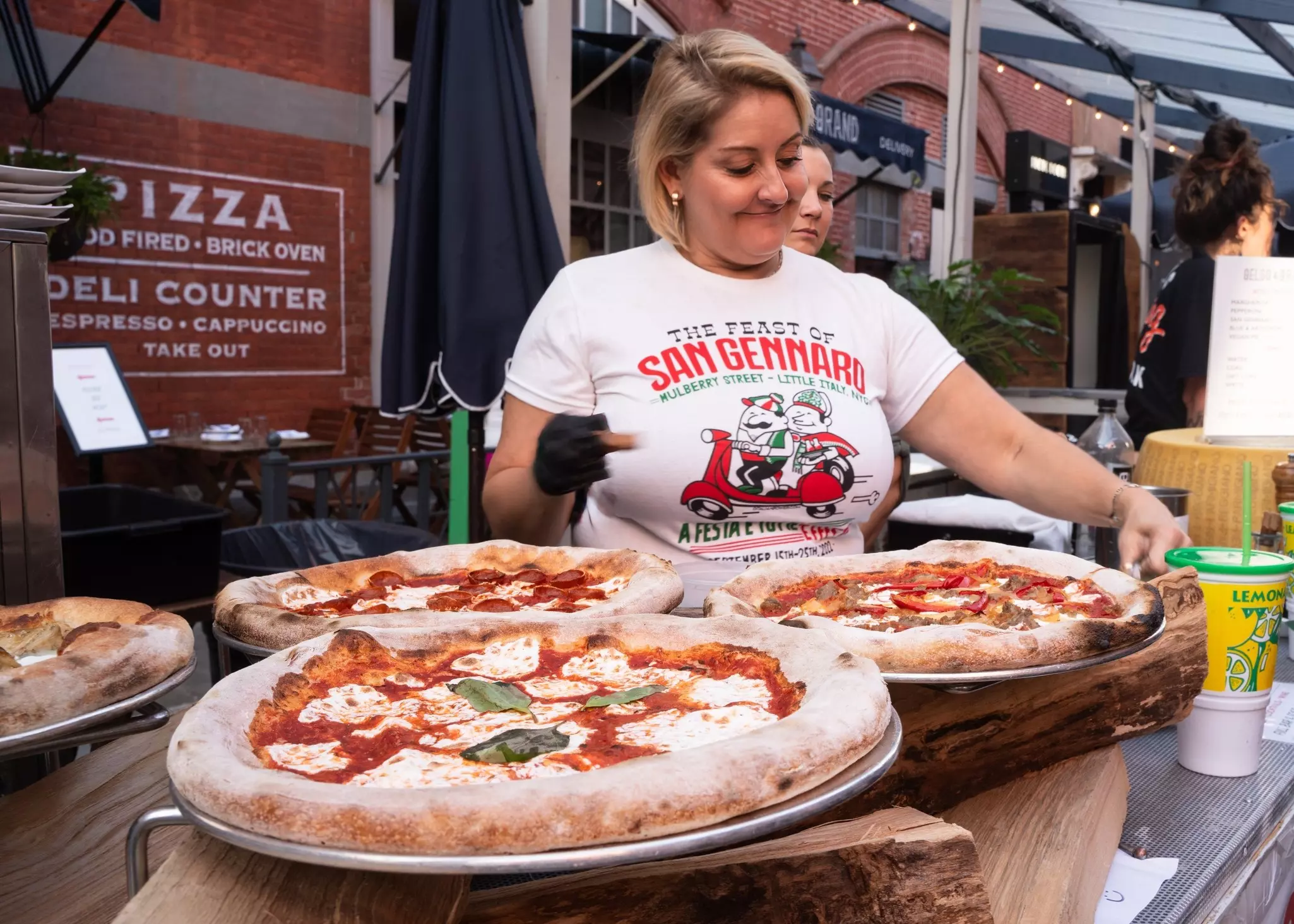 Pizzas on sale during the historic Feast of San Gennaro on Mulberry Street, Little Italy, Manhattan, New York City, USA.