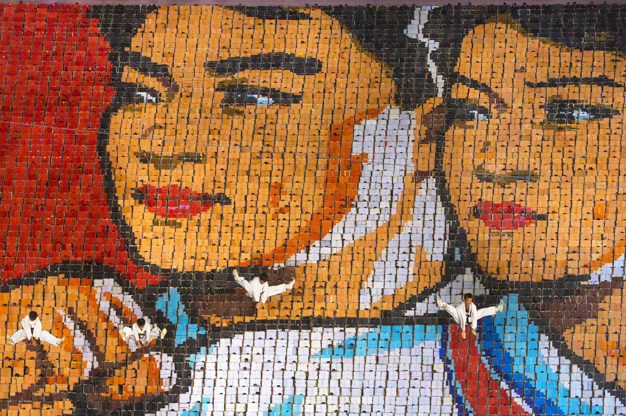 Children holding cards to form pictorial mosaic at Arirang Mass Games At May Day Stadium