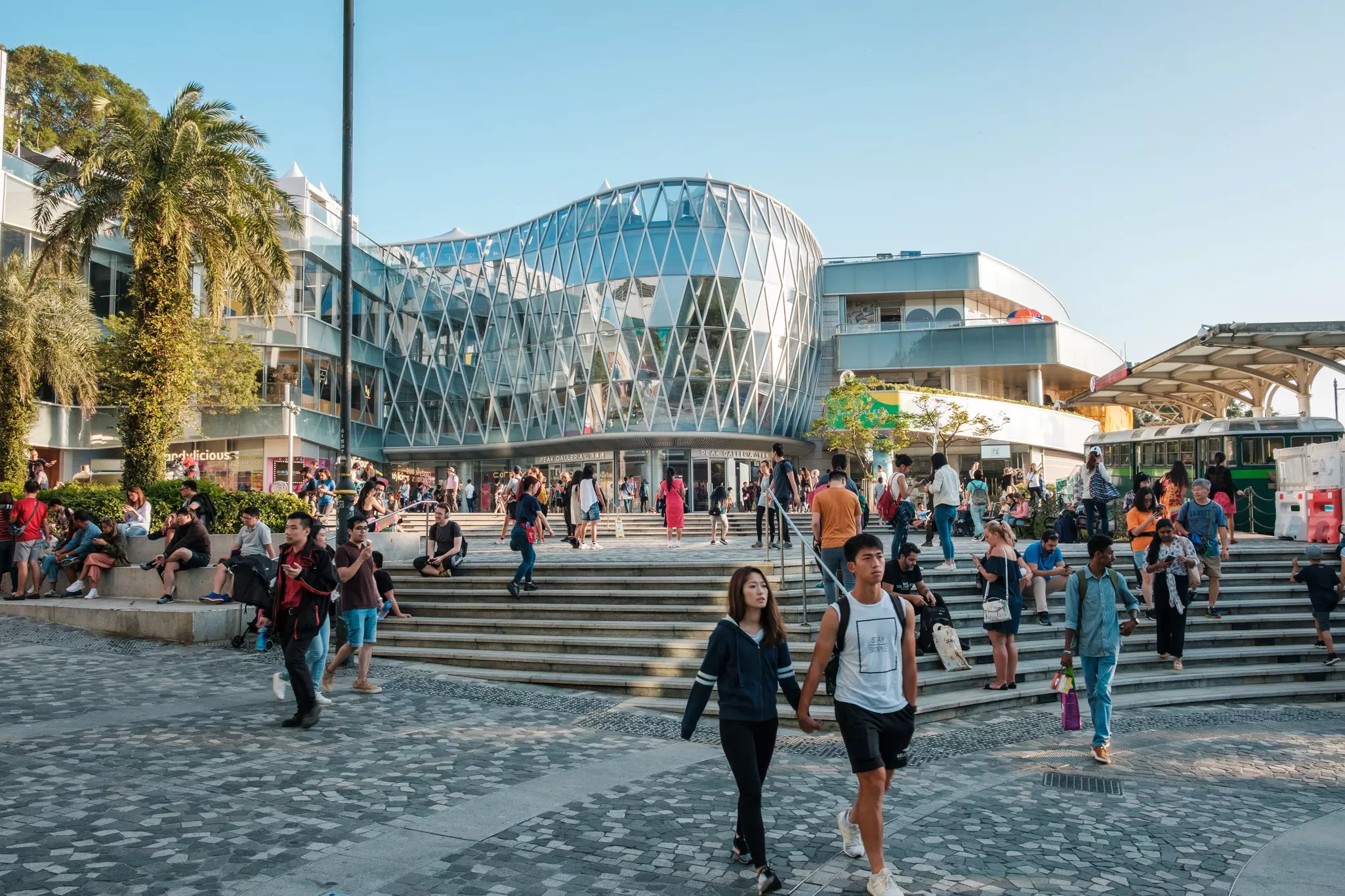 Tourists walk in front of the Peak Galleria mall at the top of Victoria Peak.