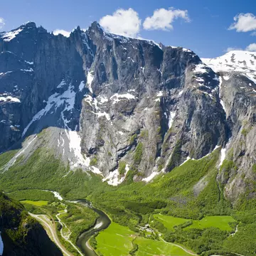 Rock face of the Trollveggen above lush green valleys.