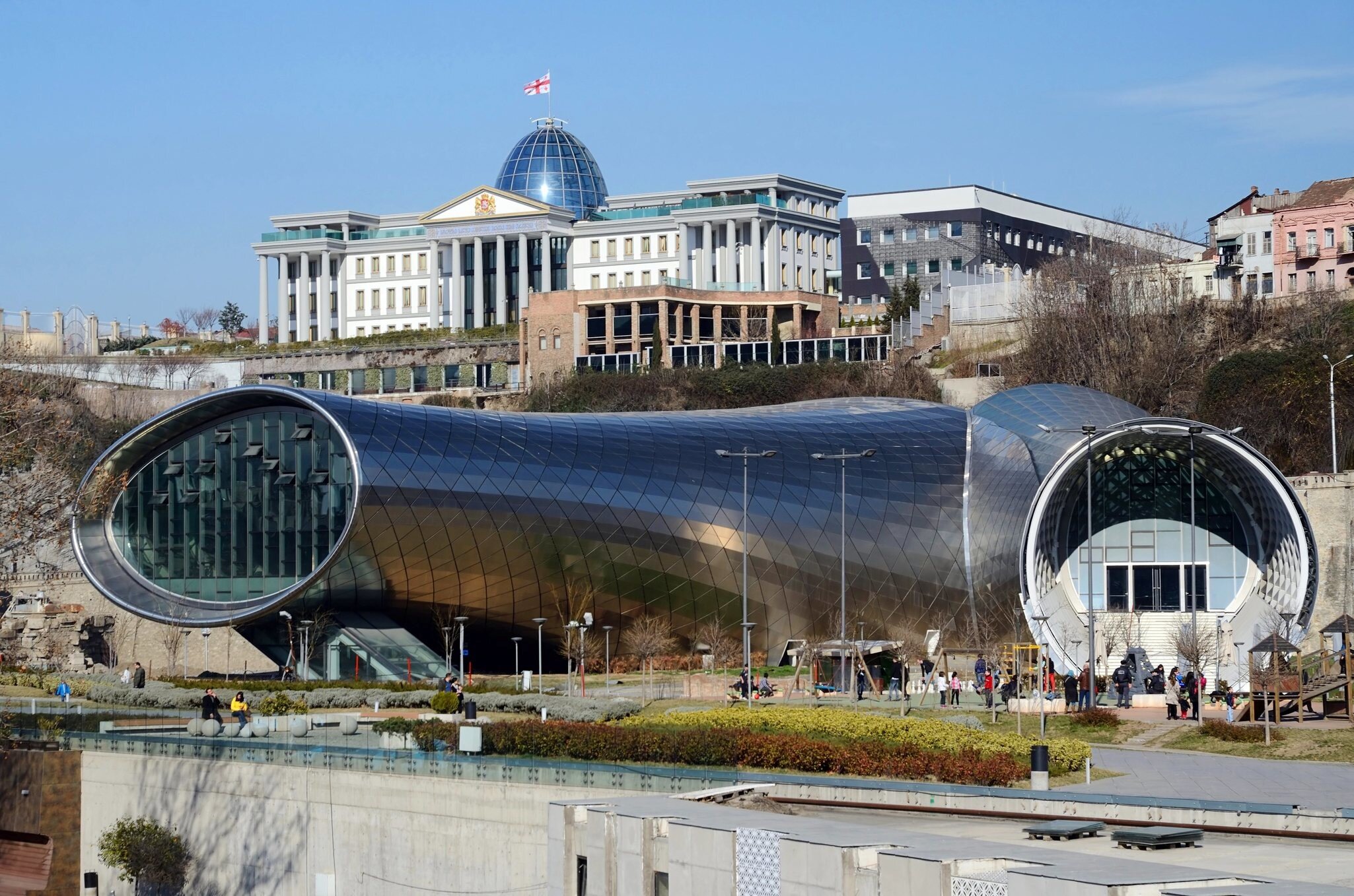 TBILISI, GEORGIA - MARCH 07, 2015: People in park in front of Concert Hall and  Official residence of Georgian President in Tbilisi, Georgia.Tbilisi is a capital and largest city ib country; 
Concert Hall & Exhibition Centre

Shutterstock ID 46237...