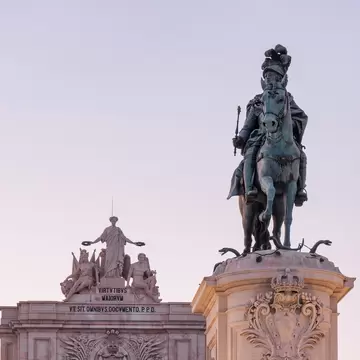 Historic statue of King José I on Praça do Comércio at dusk in the Commerce Square and Arco da Rua Augusta.