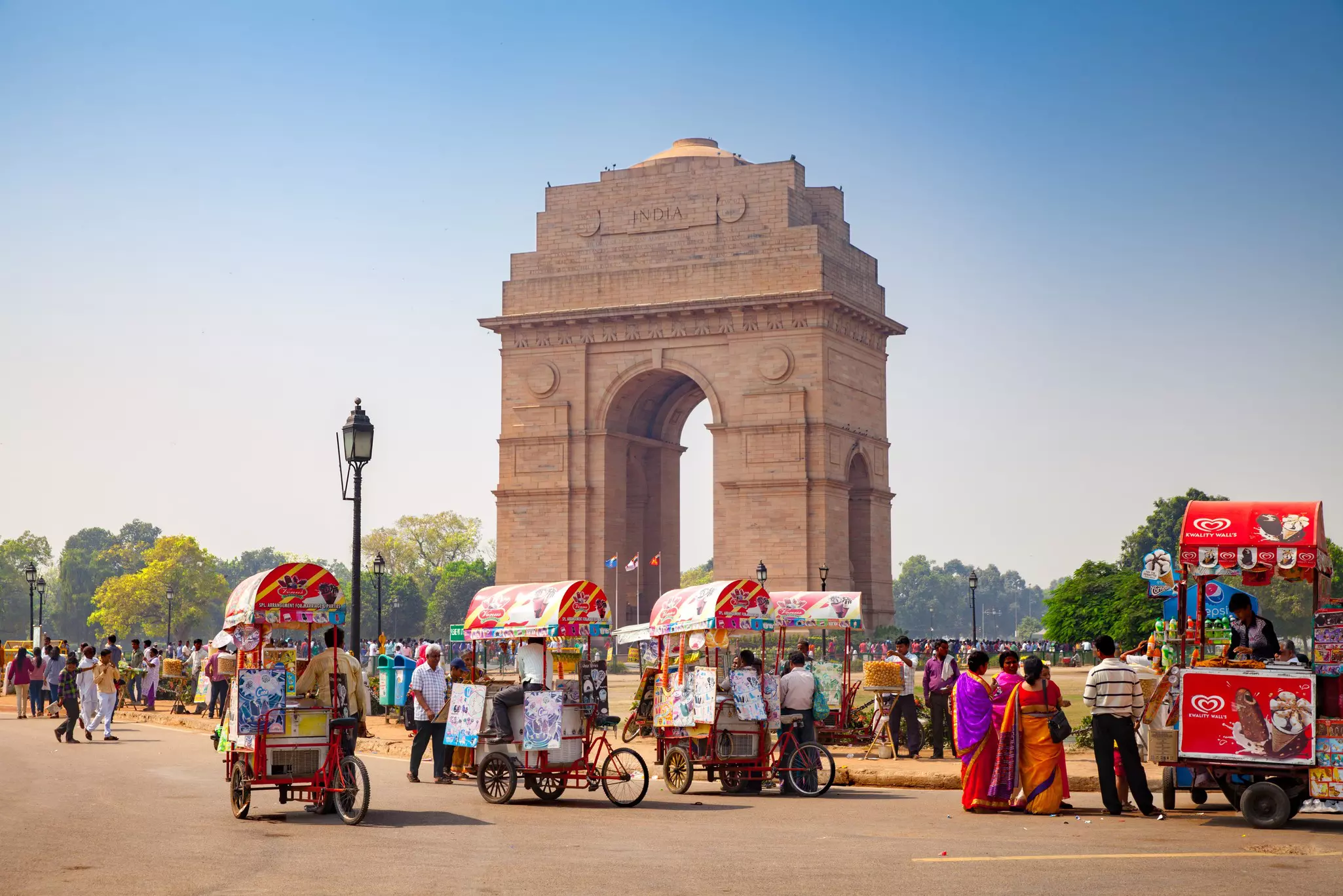Many bicycle ice cream sellers in front of the India Gate