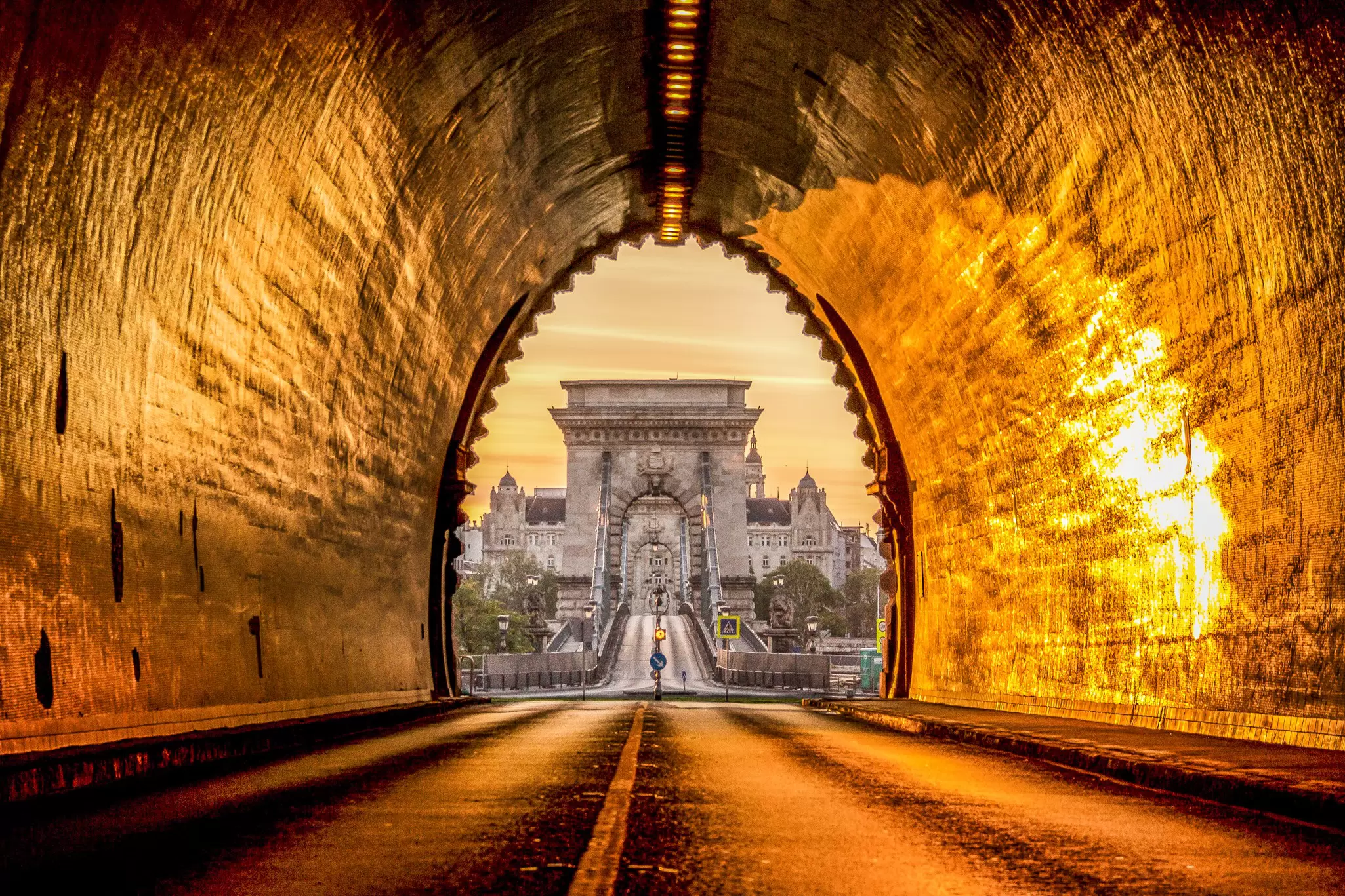 View of the Széchenyi Chain Bridge at sunrise from the Buda Castle Tunnel in Budapest, Hungary.
