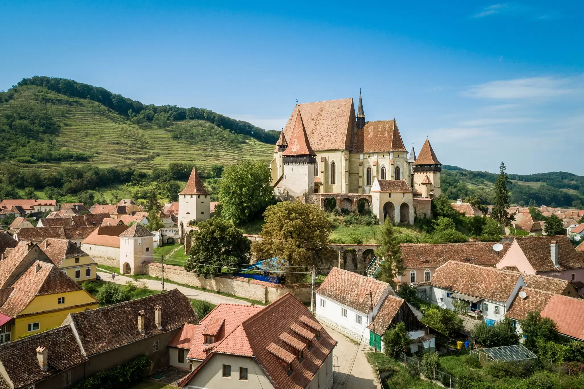 Terracotta-tiled houses around the fortified Saxon church in Biertan, Transylvania, Romania.