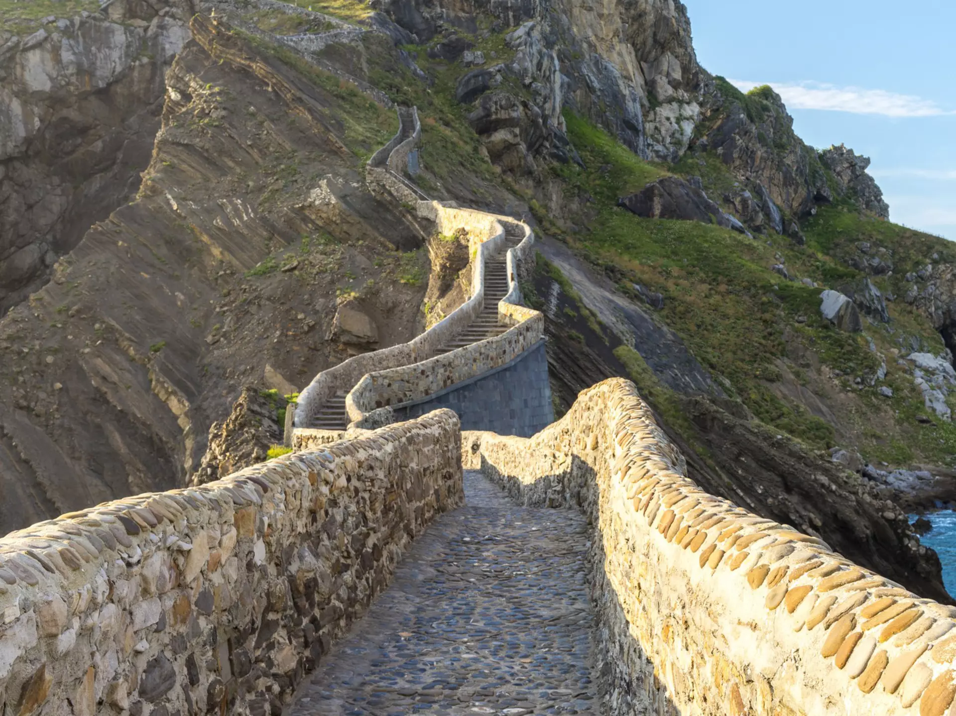 View of the man-made path leading up to the hermitage on the islet of San Juan de Gaztelugatxe in Spain.