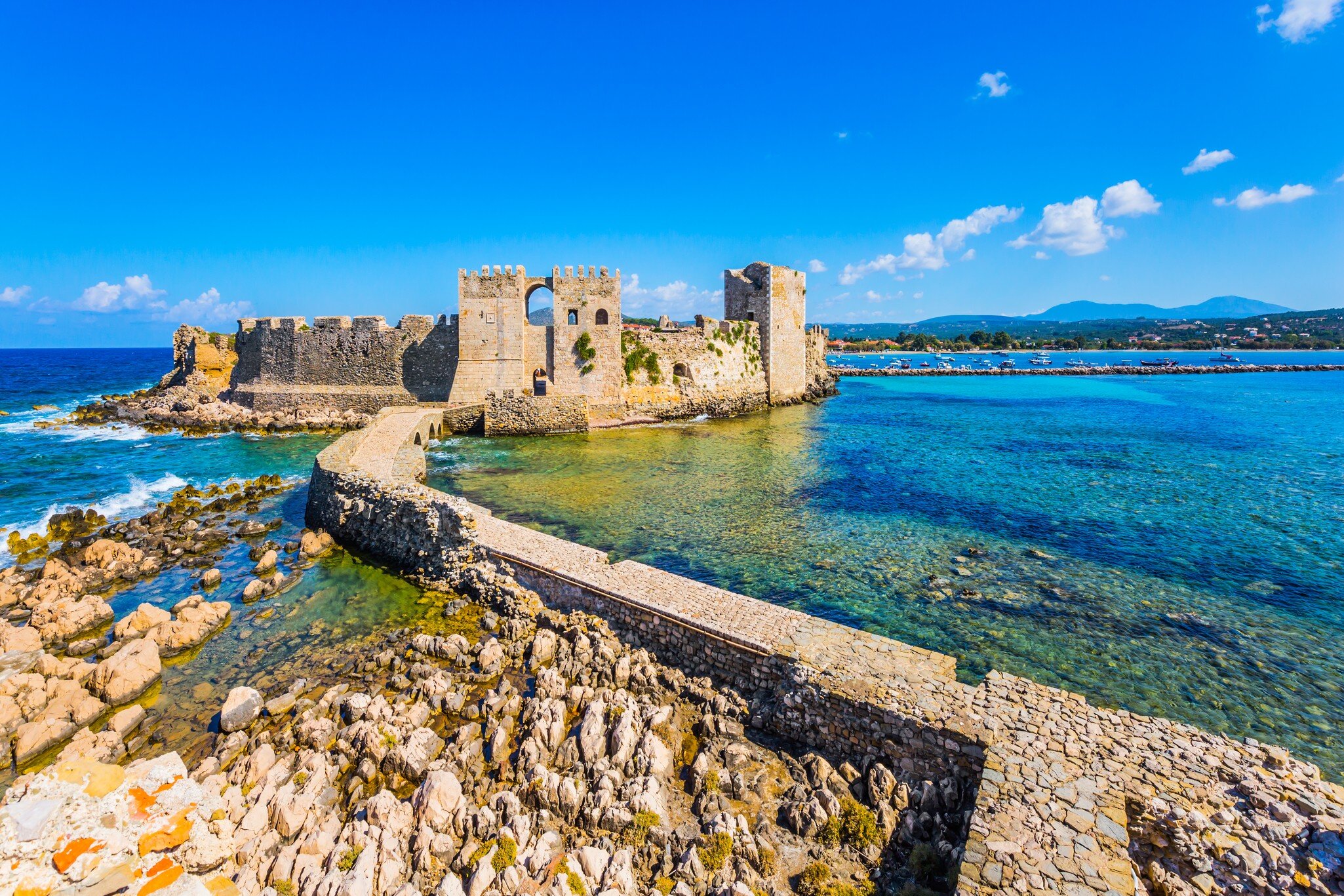 Venetian fort castle Methoni. Beautiful seaside resort in Greece Mediterranean. Blue warm sea water is great for swimming. The concept of active, phototourism and beach holiday ; Shutterstock ID 1439695043;