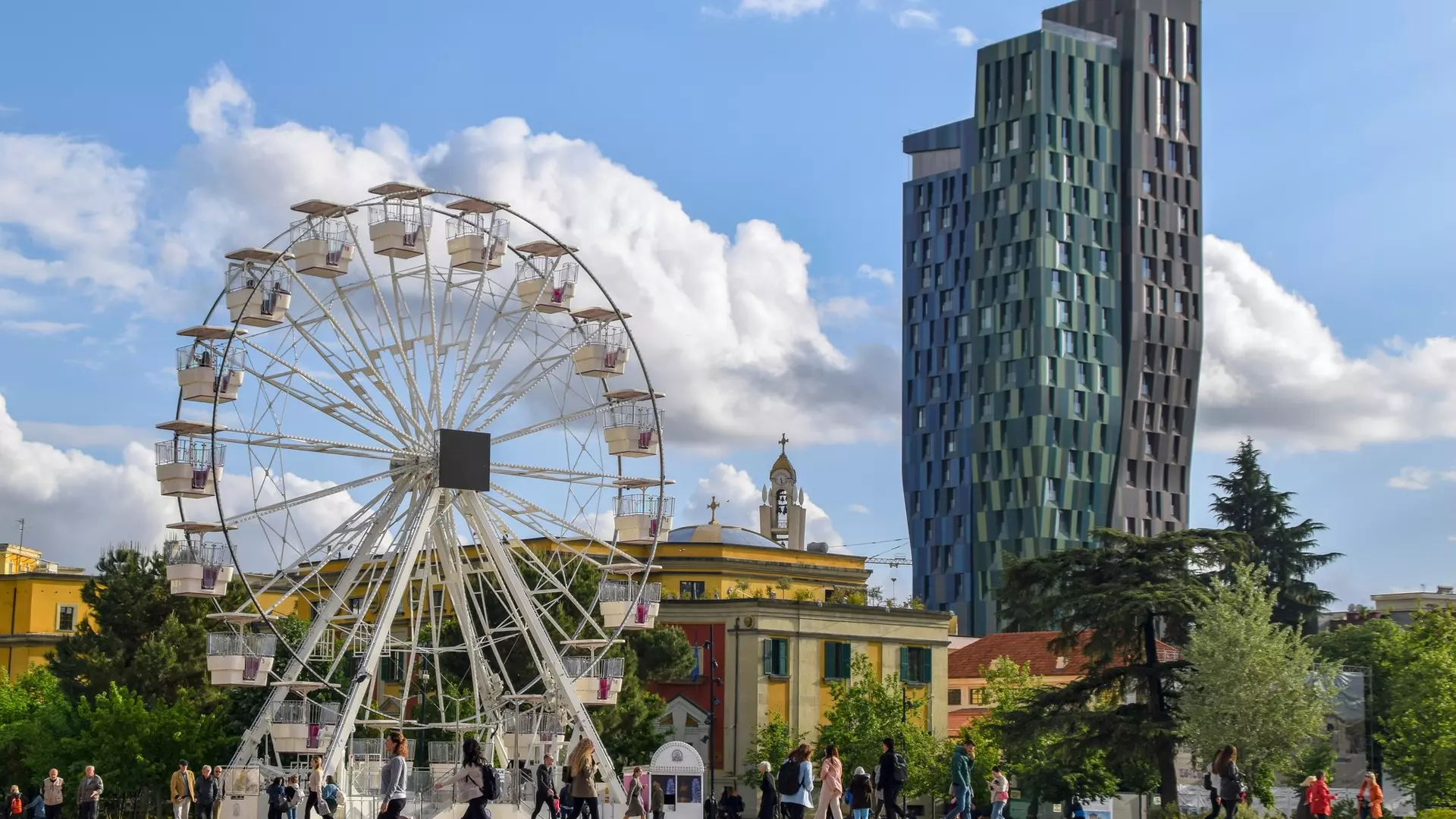 Tirana, Albania - April 20 2024:Local people and tourists at the Skanderbeg Square (Sheshi Skënderbej), the main plaza in Tirana, close to the National Theatre of Opera and Ballet of Albania.