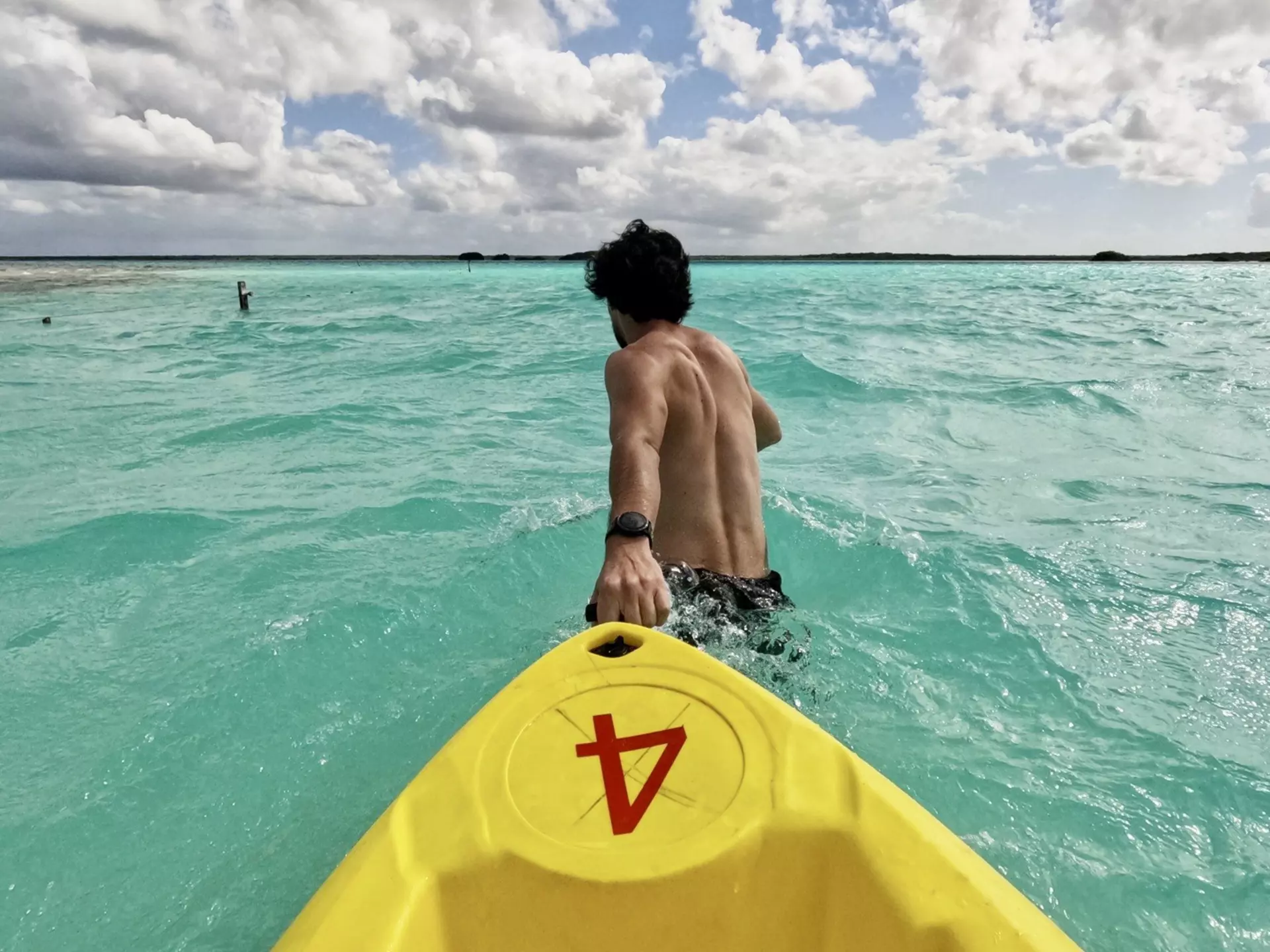 A kayaker in Laguna Bacalar. Ghecipol/Shutterstock