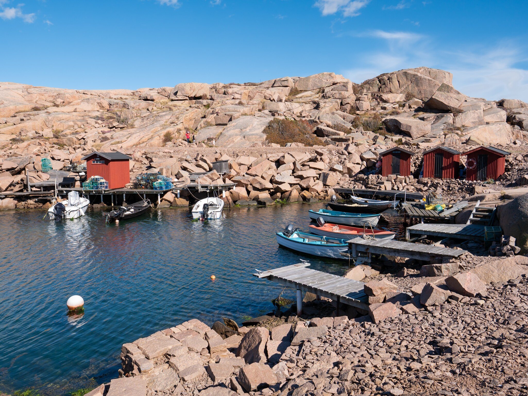 Lysekil, Sweden - Aug 17, 2025: Small boat harbour with red wooden huts and moored boats among granite rocks in Stångehuvud nature reserve, Lysekil, Bohuslän, west coast Sweden, License Type: media, Download Time: 2026-06-04T18:31:17.000Z, User: LP_NZhan, Editorial: true, purchase_order: 65050 - Digital Destinations and Articles, job: App Content, client: Lonely Planet, other: Nadine Zhan