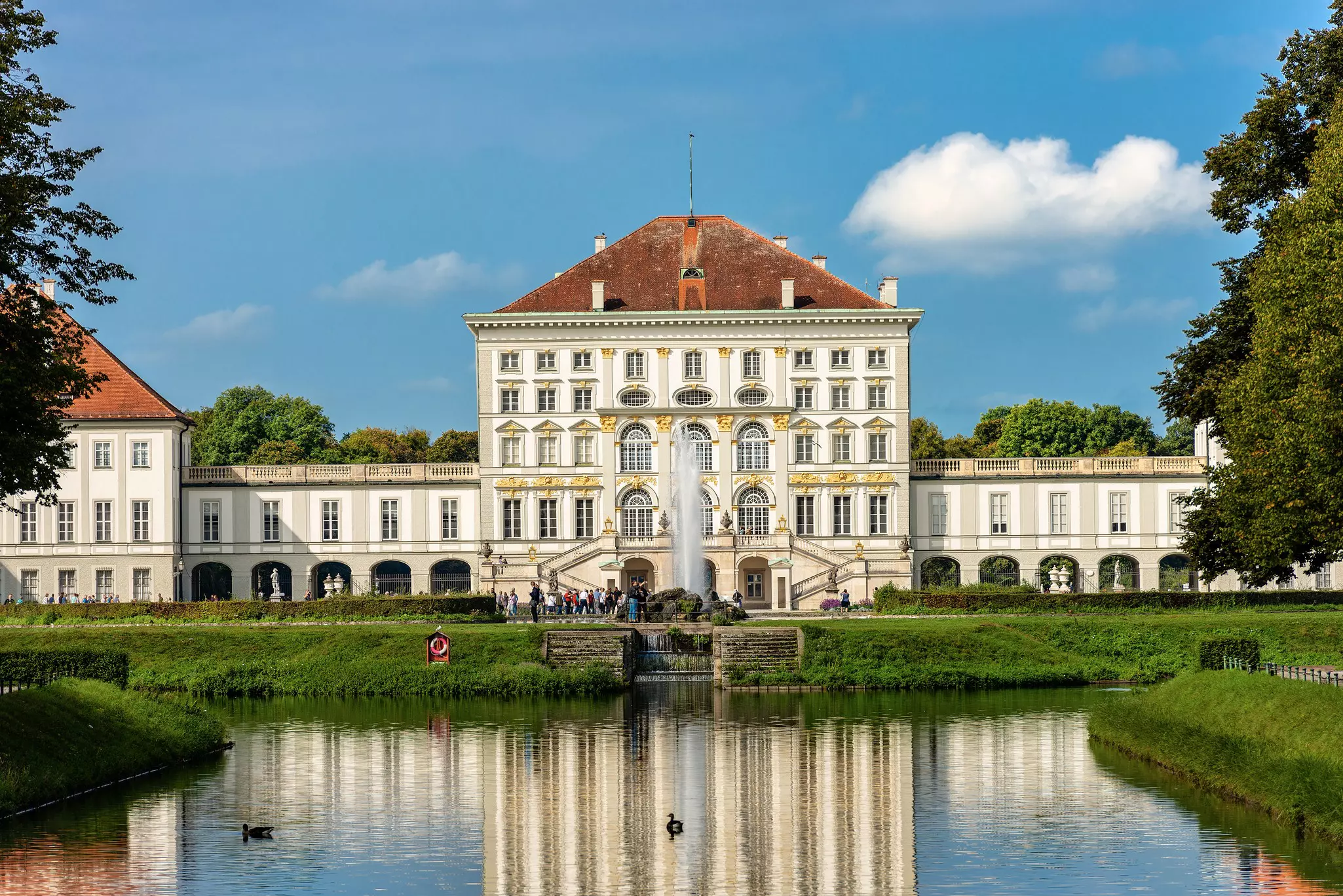 A view of Nymphenburg Palace (Schloss Nymphenburg), the former summer residence of the rulers of Bavaria, with swans in the reflecting pool in front, Munich, Germany
