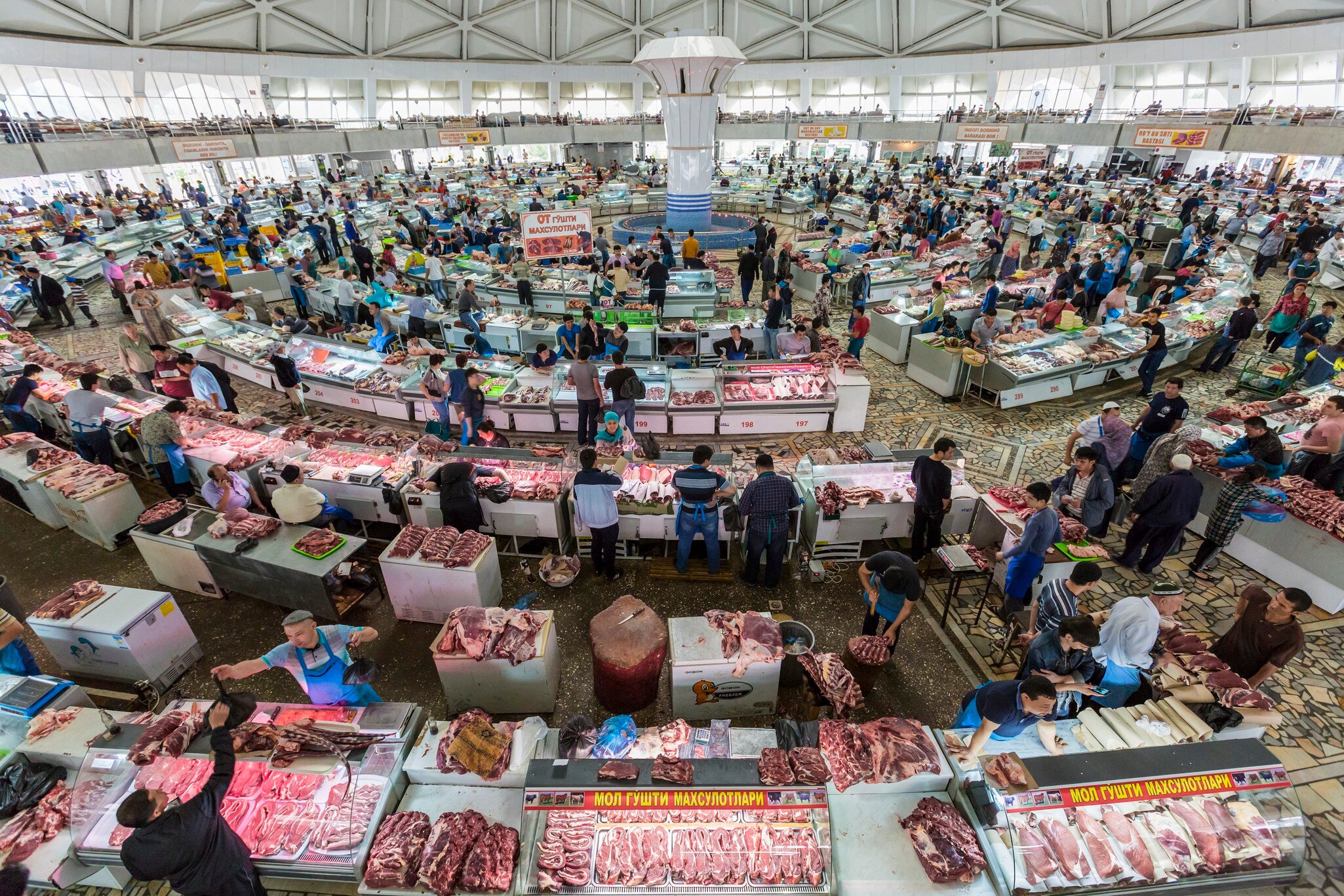 Tashkent, Uzbekistan - May 17, 2016: People shop in the meat section of the Chorsu Bazaar in Tashkent, Uzbekistan