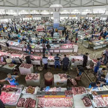 Tashkent, Uzbekistan - May 17, 2016: People shop in the meat section of the Chorsu Bazaar in Tashkent, Uzbekistan
