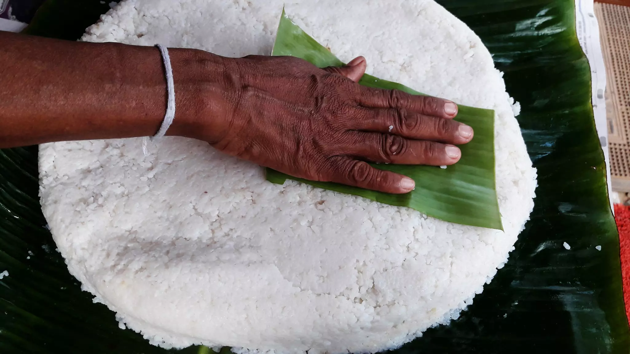 Preparing kiribath, made from rice and coconut milk. designfacts/Shutterstock