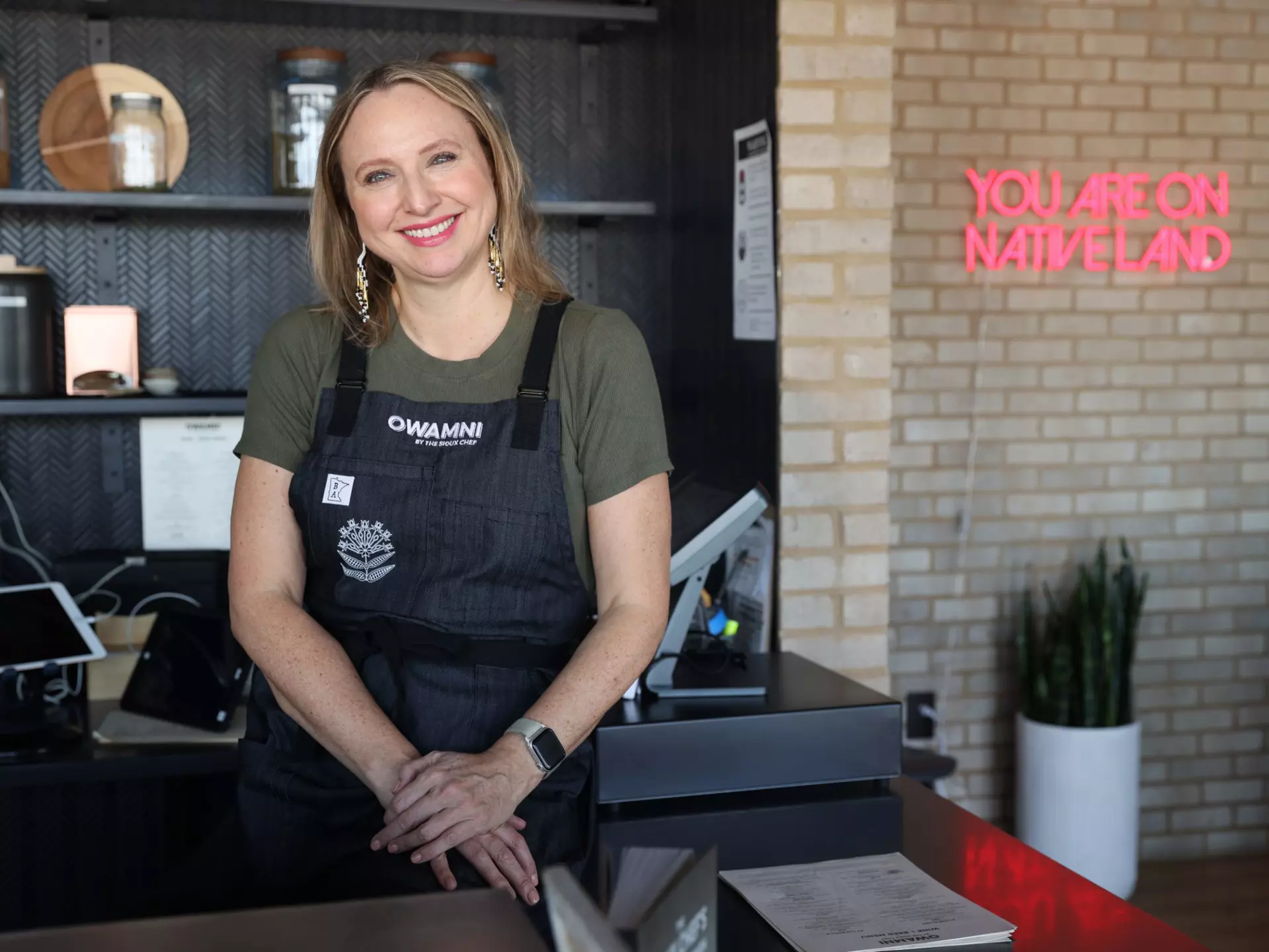 Dana Thompson at the hostess counter at Owamni