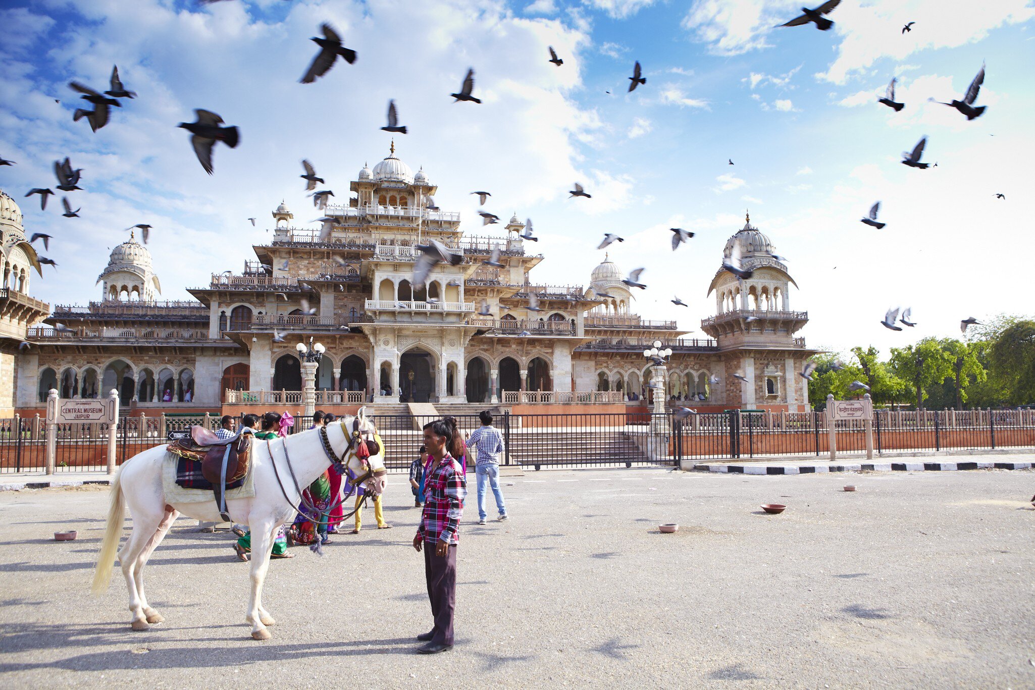 View of a horse and a man outside the Central Museum in Jaipur, India.