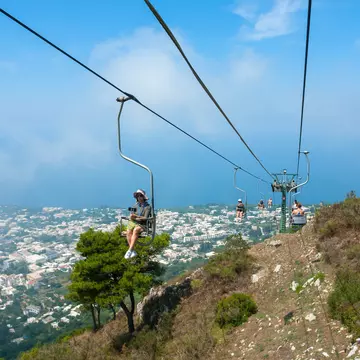 July 29, 2018: People riding up the mountain chair lift in Capri.