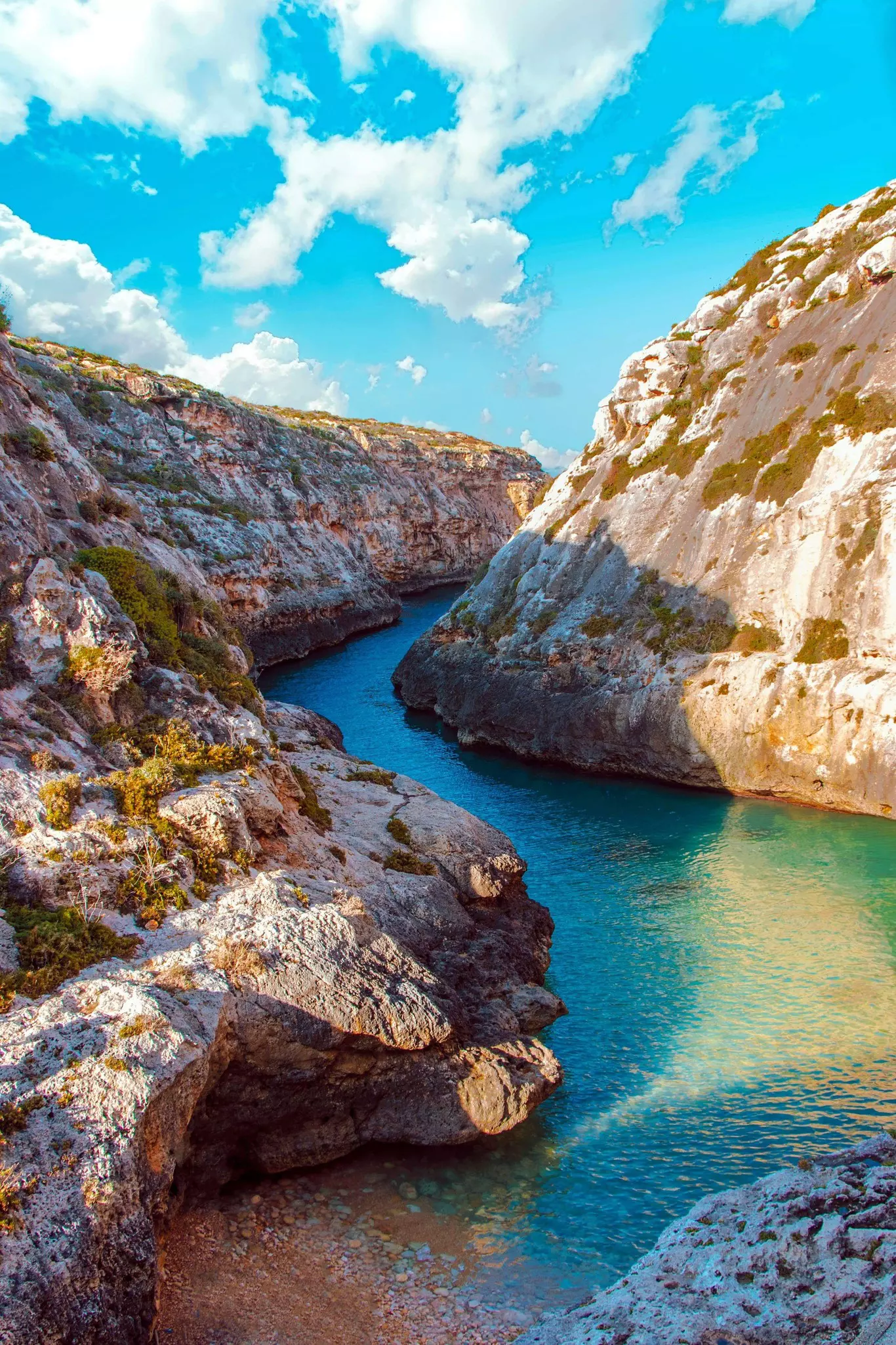 A narrow water channel between cliffs