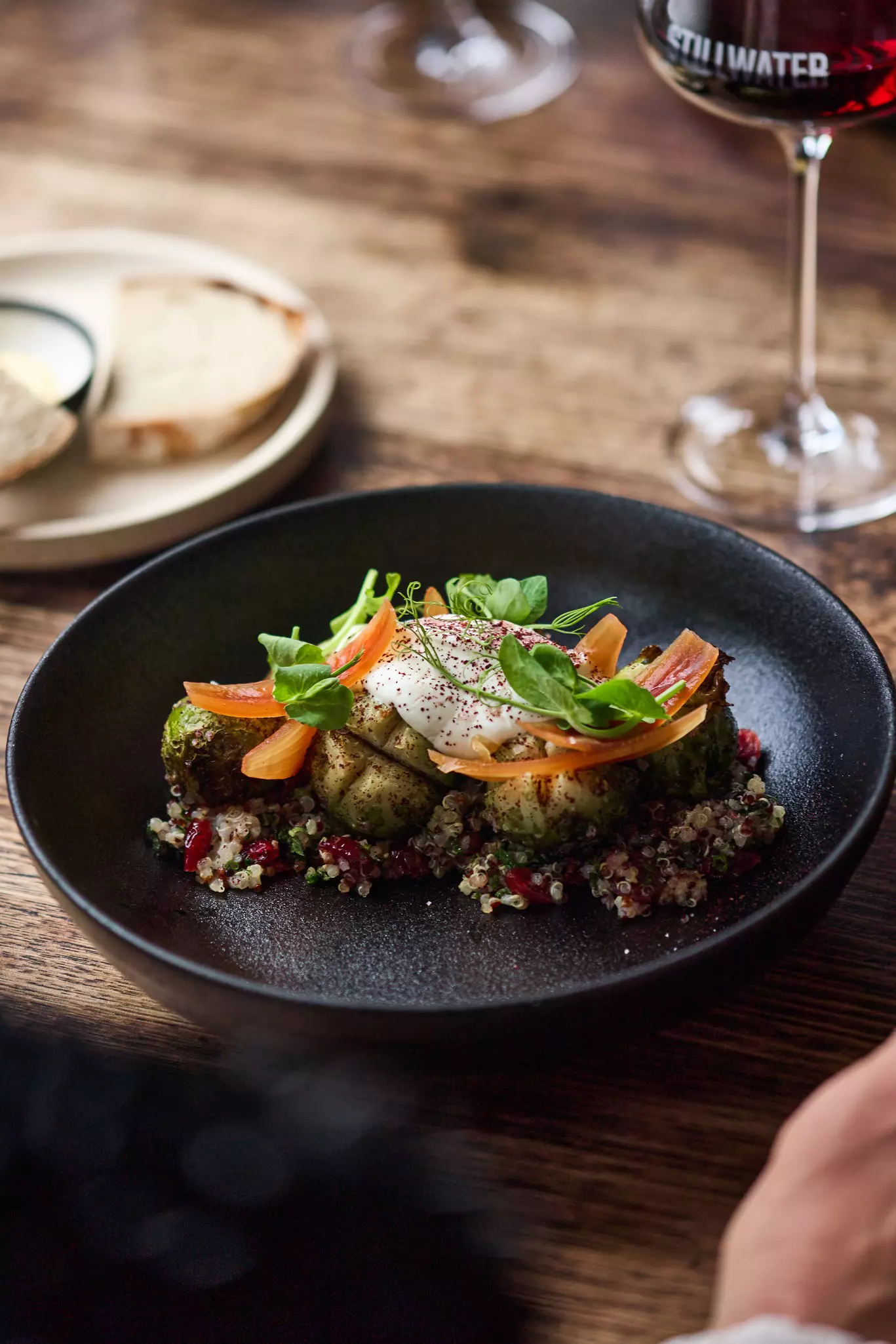 Grains and greens on black bowl