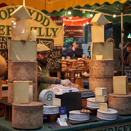 London, UK - February, 2019. Street food stall selling cheese in Borough Market., License Type: media, Download Time: 2025-07-29T19:09:20.000Z, User: katelyn.perry_lonelyplanet, Editorial: true, purchase_order: 65050 - Digital Destinations and Articles, job: wip, client: wip, other: Katelyn Perry