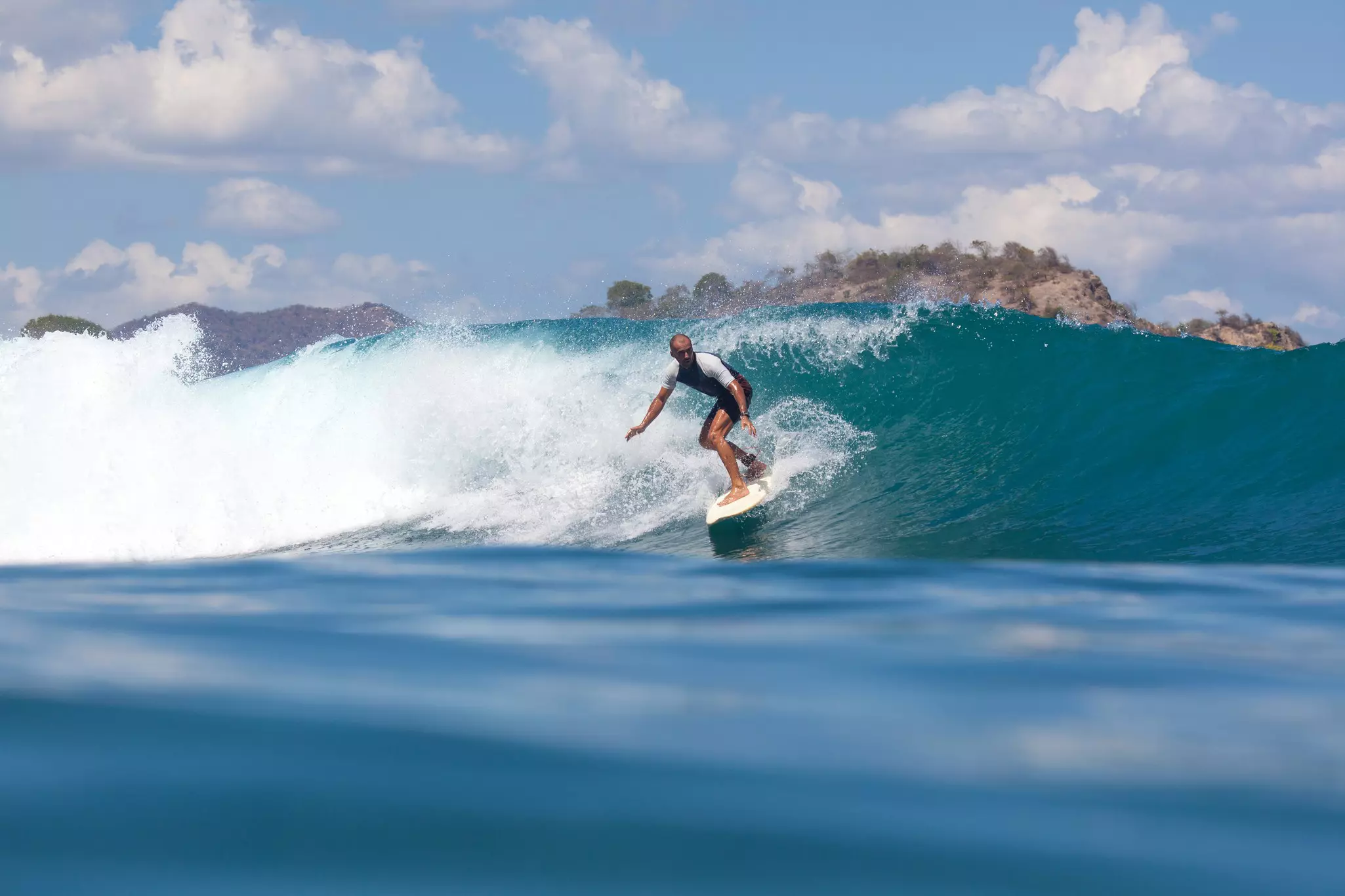 A man surfing a wave, Sumbawa island, Indonesia.