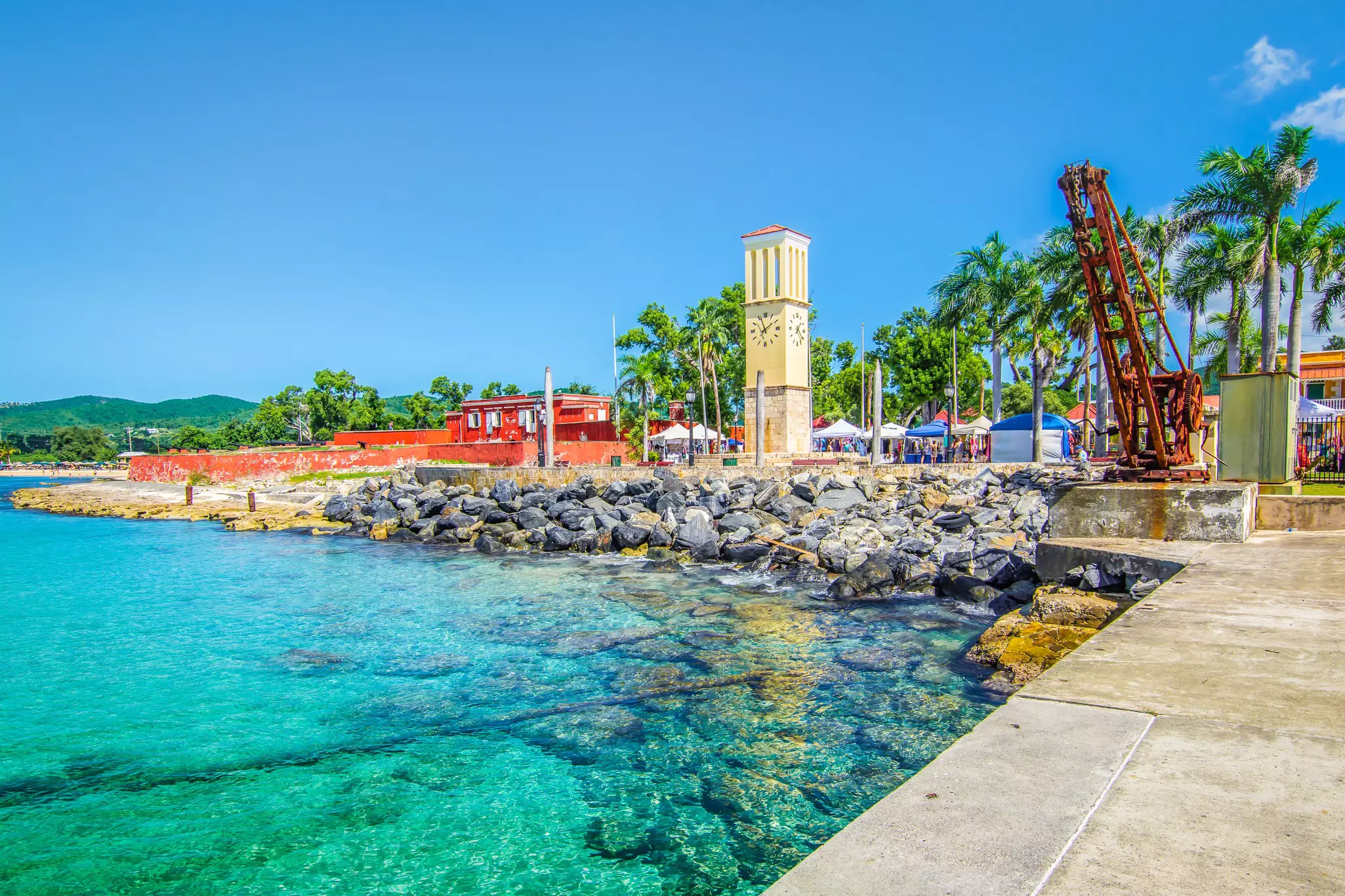 The Frederiksted cruise port with old Fort Frederik and clock tower at the waterfront on a sunny day