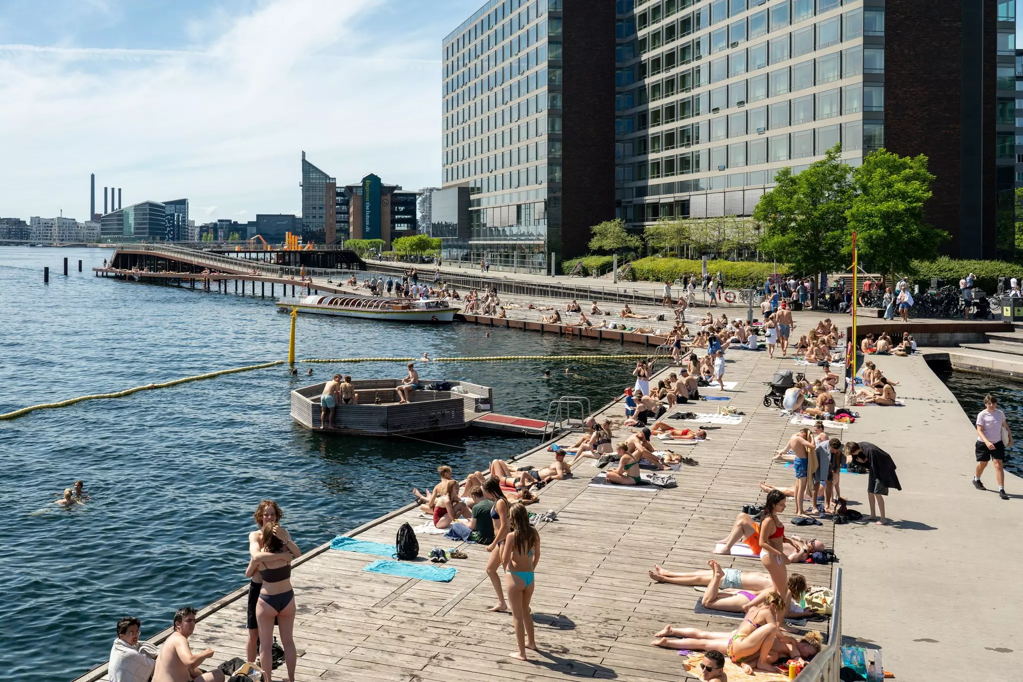 People sunbathing on the wooden promenade at Kalvebod Bølge in Copenhagen. 