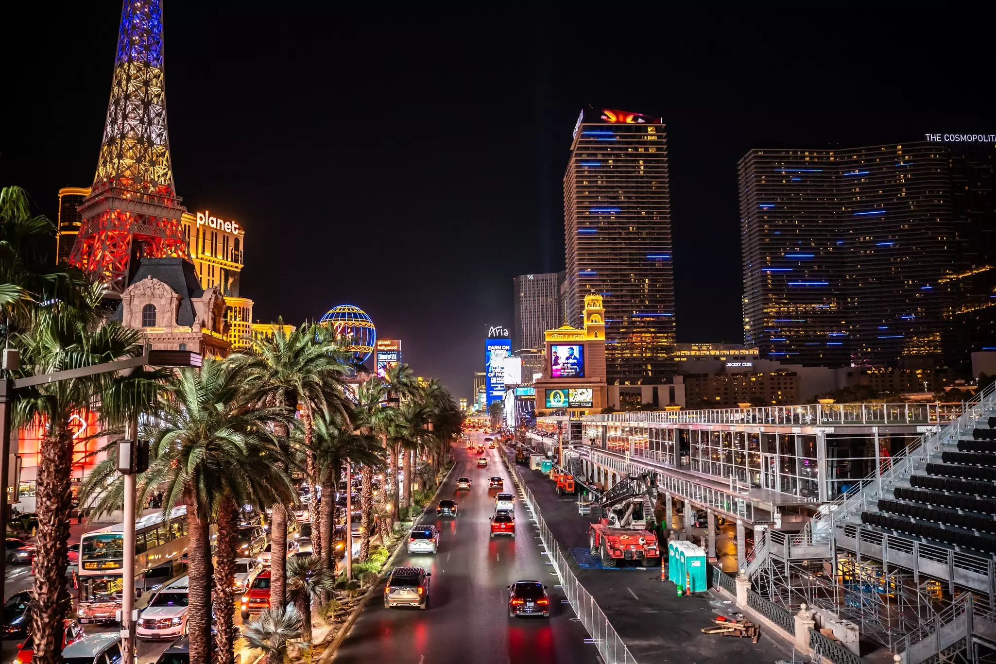 Cars drive down the Las Vegas Strip, surrounded by neon lights, USA.