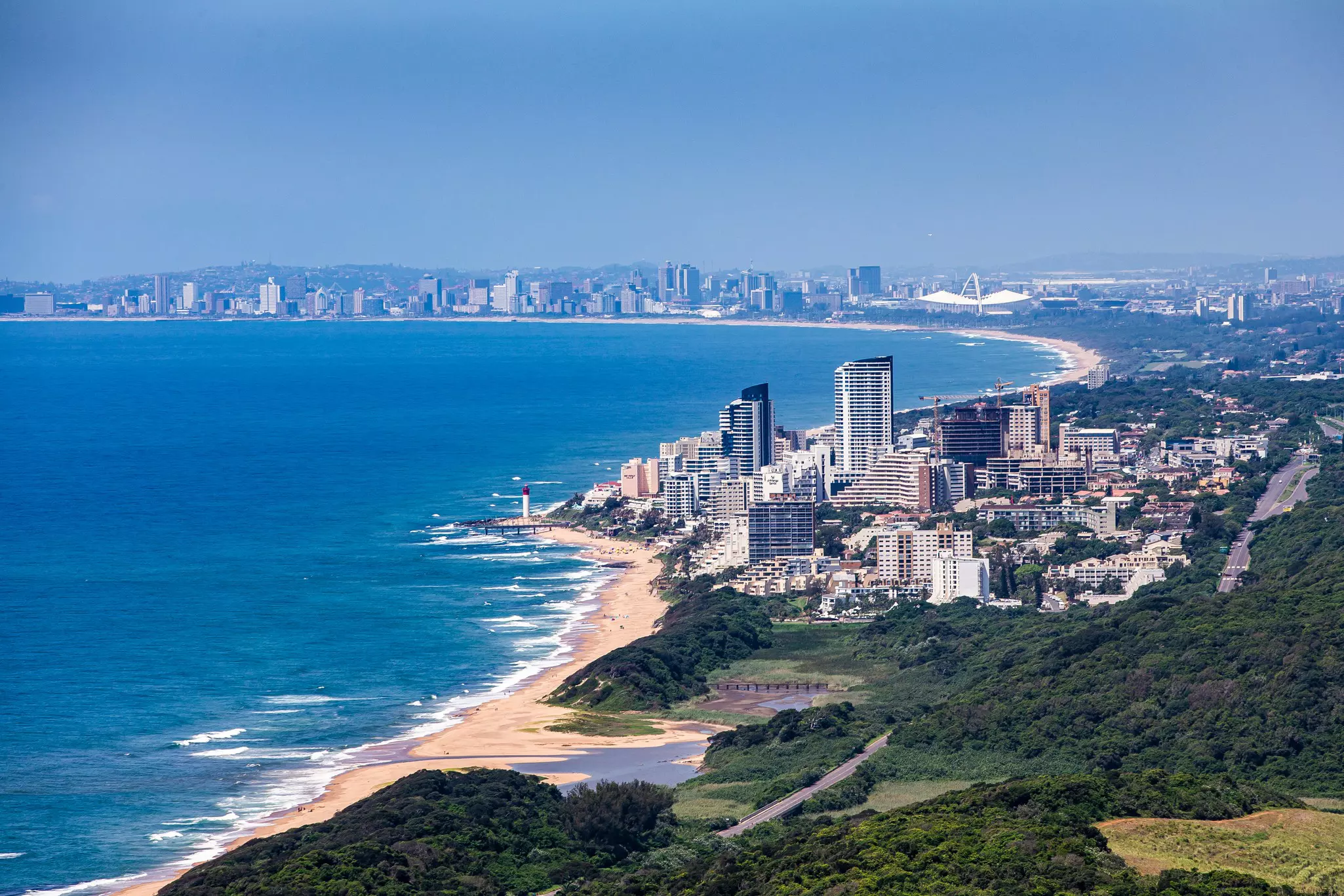 A high-rise coastal city with a long line of golden sandy beaches.