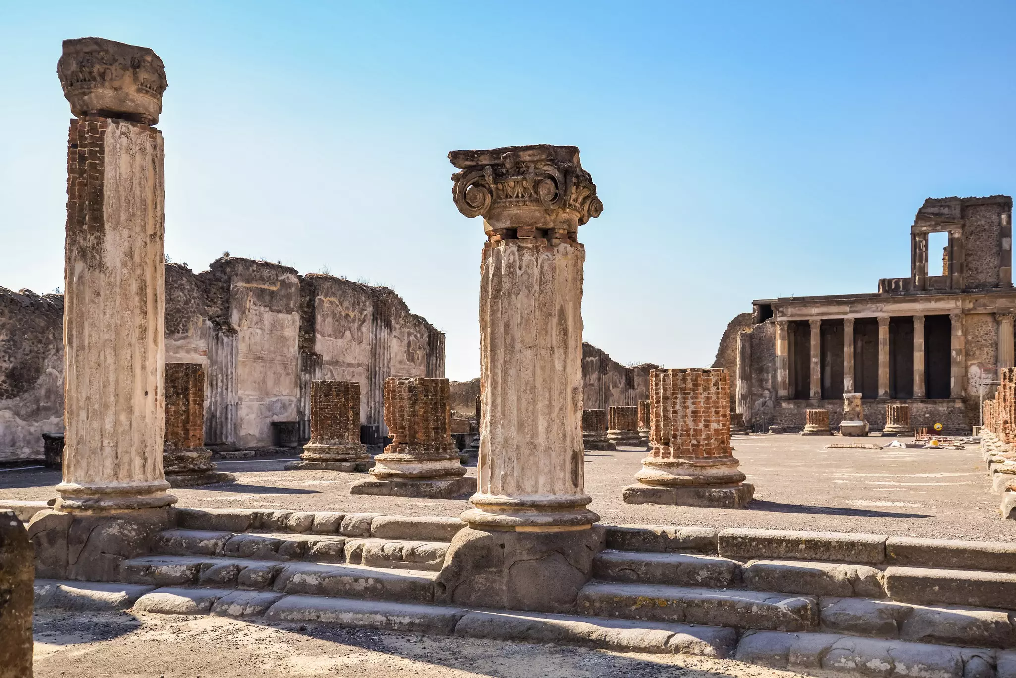 View Roman archeological ruins, including columns and buildings, from the lost city of  Pompeii in Italy.