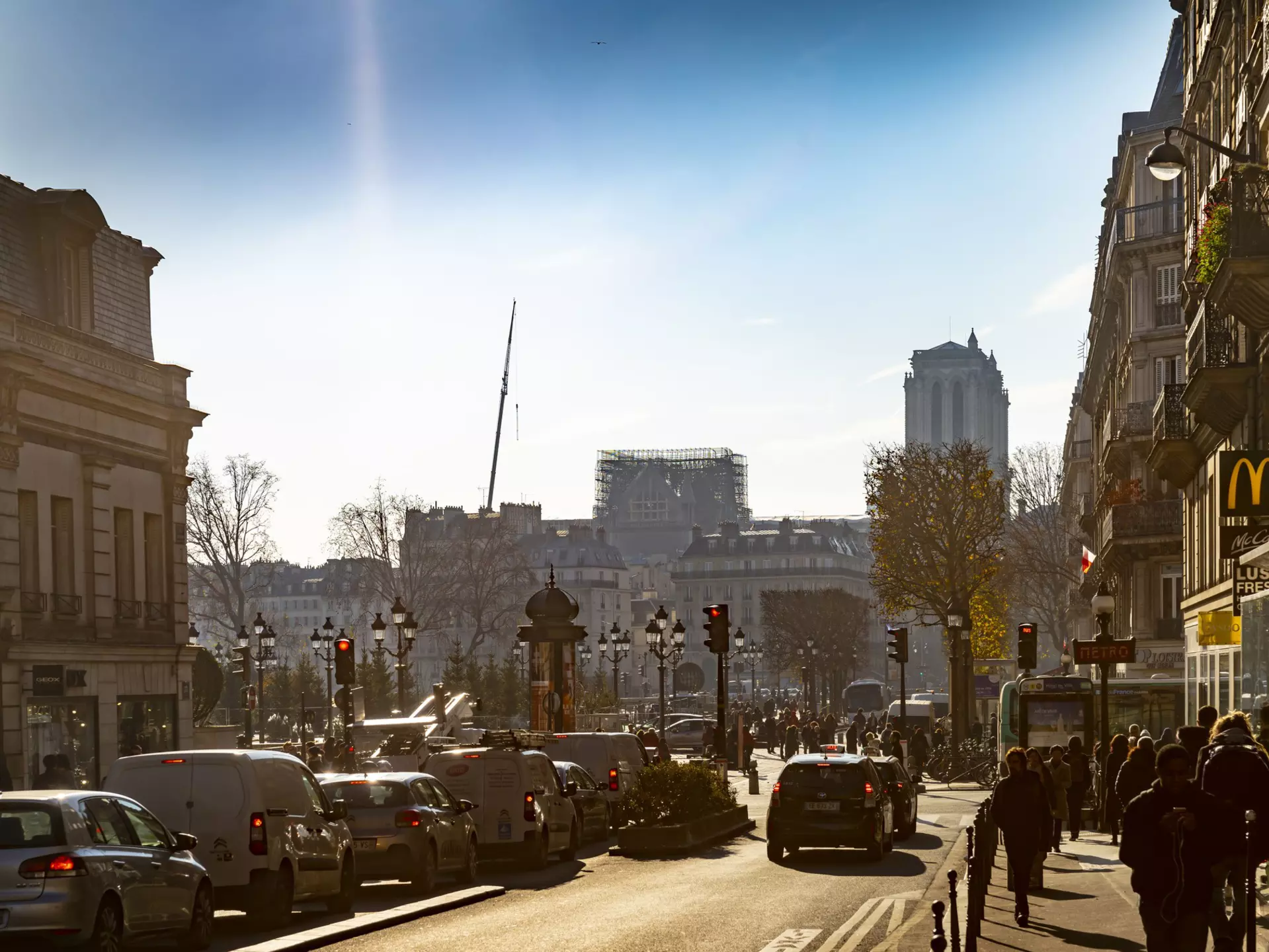 April 2019: Traffic in Paris near the damaged Notre Dame, which is is half-covered with scaffolding after a major fire in April 2019.
1197085659
French Culture, History, Transportation, Cathedral, Old, No People, 2019, Travel Destinations, Horizontal, Built Structure, Passenger Craft, Facade, Mode of Transport, Back Lit, Polarizer, Photography, Notre Dame de Paris, Outdoors, Public Transportation, Side Lit, Famous Place, International Landmark, Day, Sky, Car, Town, City Life, Church, Europe, Tourism, Capital Cities, City Street, Stationary, Street, France, Traffic, Travel, Building Exterior, Paris - France, Cityscape, Architecture, Scaffolding, Road, Tower, Tourist, Sailing, Urban Skyline, City, Sun, Ile de la Cite, Ferry, Winter