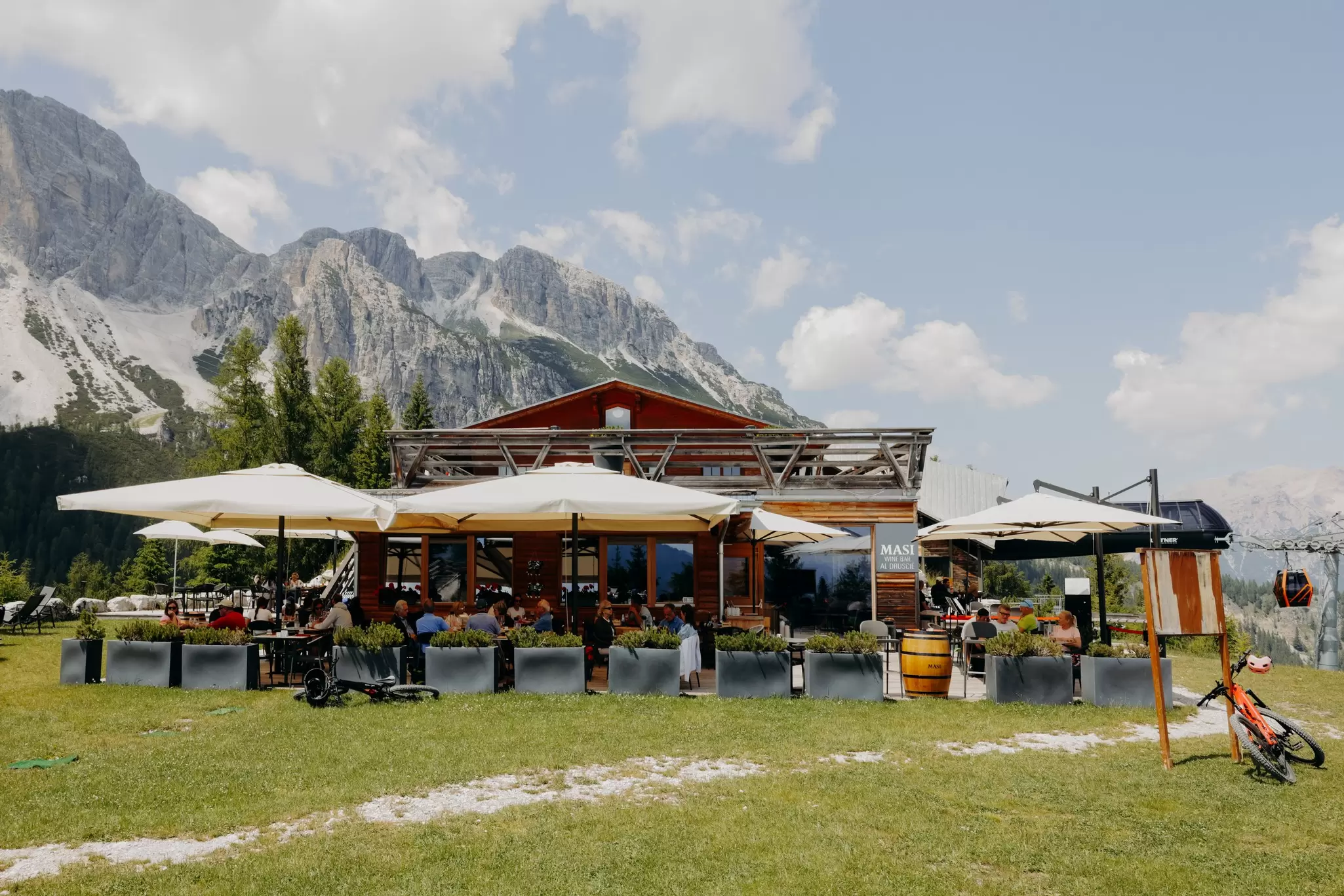 Cortina d'Ampezzo, Italy. June 2025. ..Masi Wine Bar, located in Col Druscié (1778m). The Freccia nel Cielo (Arrow in the Sky) lift, which reaches the top of the Tofane Mountains and has three stops: Col Druscié at 1778m, Ra Valles at 2470m and Tofana di Mezzo at 3244m...Photo by Camilla Ferrari for Lonely Planet