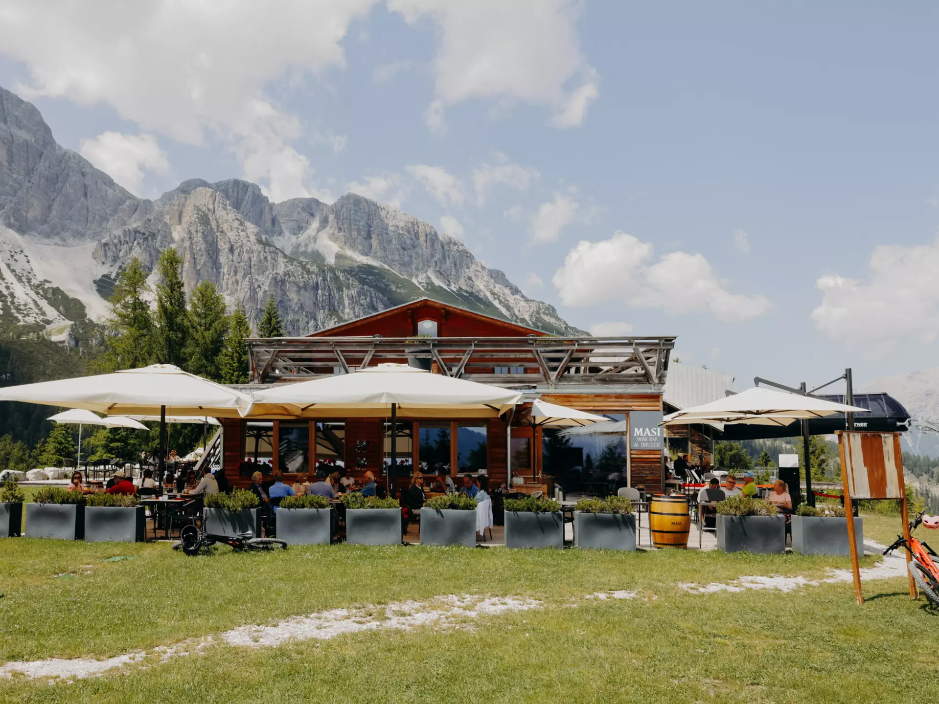 Cortina d'Ampezzo, Italy. June 2025. ..Masi Wine Bar, located in Col Druscié (1778m). The Freccia nel Cielo (Arrow in the Sky) lift, which reaches the top of the Tofane Mountains and has three stops: Col Druscié at 1778m, Ra Valles at 2470m and Tofana di Mezzo at 3244m...Photo by Camilla Ferrari for Lonely Planet